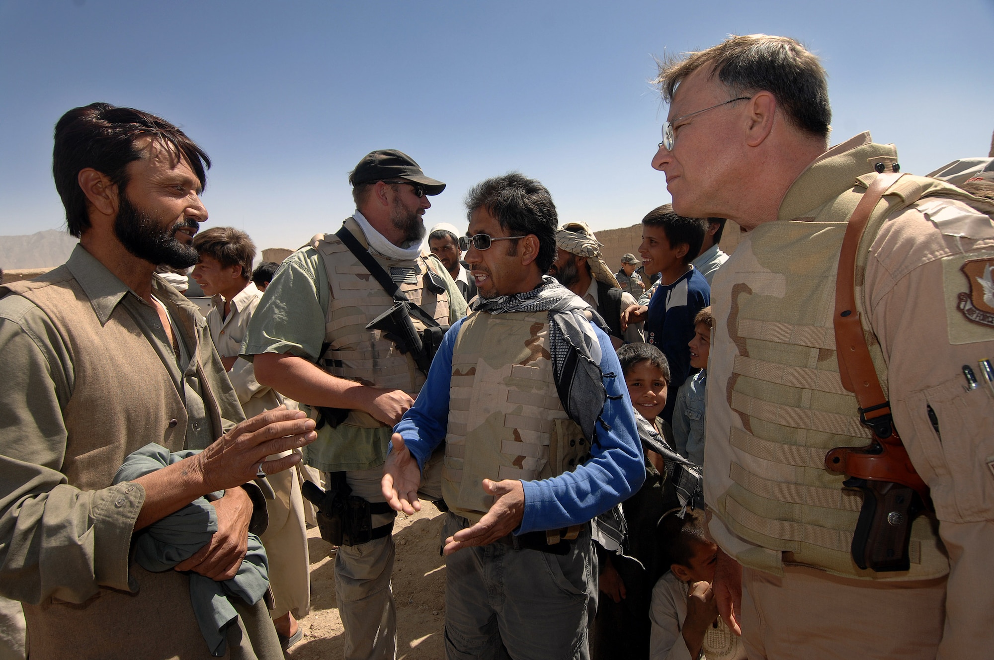 A village elder greets Lt. Gen. John Bradley June 17 in the village of Qal' ehye Yuzbashi in Afghanistan. General Bradley was delivering humanitarian supplies to the village located near Bagram Air Base. The supplies, destined for refugee camps, orphanages and hospitals throughout Southwest Asia, are part of the 9,000 pounds collected by General Bradley's wife, Mrs. Jan Bradley. General Bradley, chief of the Air Force Reserve and Air Force Reserve Command commander, is visiting Airmen throughout Southwest Asia to thank them for their service supporting the war on terrorism. (U.S. Air Force photo/Tech Sgt. Rick Sforza)