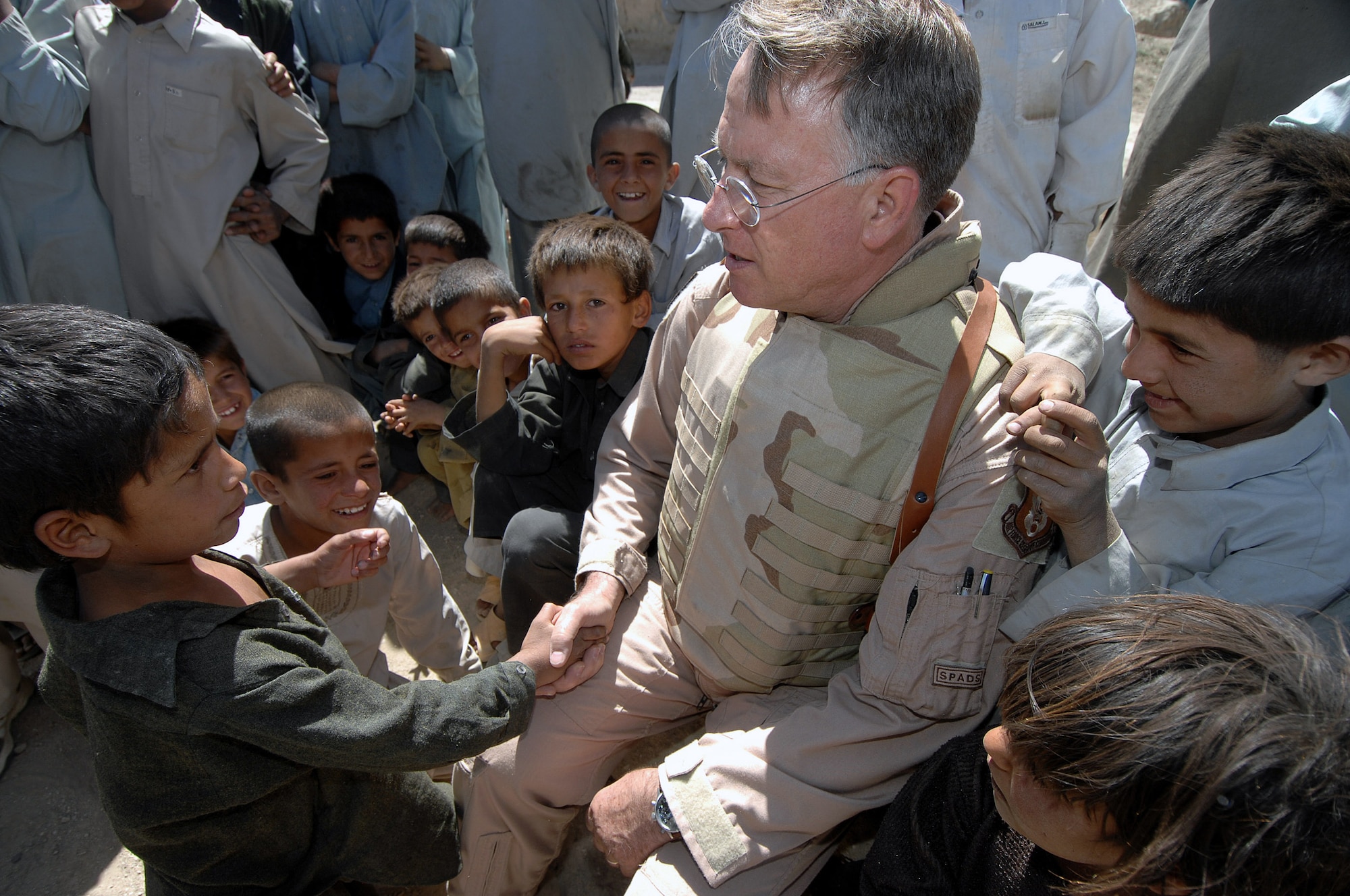 Children greet Lt. Gen. John Bradley June 17 in the village of Qal' ehye Yuzbashi in Afghanistan. General Bradley was delivering humanitarian supplies to the village located near Bagram Air Base. The supplies, destined for refugee camps, orphanages and hospitals throughout Southwest Asia, are part of the 9,000 pounds collected by General Bradley's wife, Mrs. Jan Bradley. General Bradley, chief of the Air Force Reserve and Air Force Reserve Command commander, is visiting Airmen throughout Southwest Asia to thank them for their service supporting the war on terrorism. (U.S. Air Force photo/Tech Sgt. Rick Sforza)