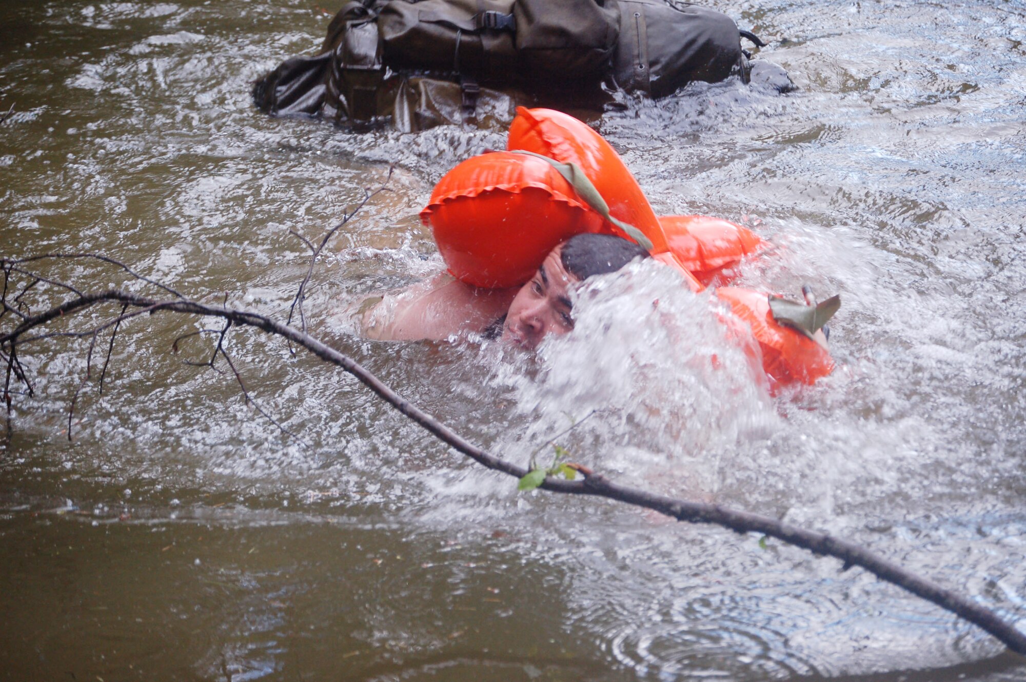 A competitor in the 2007 SERE (survival, evasion, resistance and escape) Challenge approaches the shore after a 300-meter swim through frigid water in Colville National Forest near Fairchild Air Force Base, Wash. The SERE Challenge was open to members of the Guardian Angel weapons system: SERE specialists; pararescuemen; and combat rescue officers. Fifteen two-man teams competed to demonstrate their mastery of survival and combat skills June 11-14. (U.S. Air Force photo/Staff Sgt. Matthew Rosine)