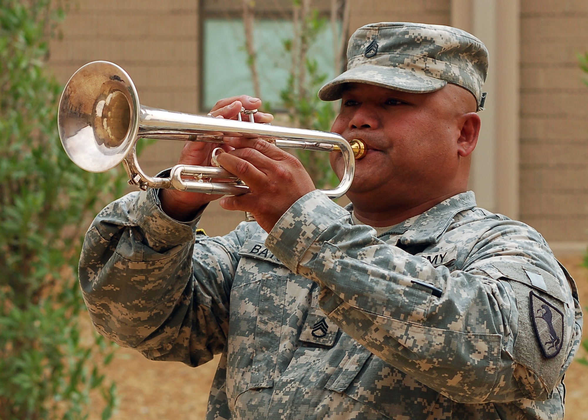 Army Sgt. Ronald Batula plays "Taps" during a memorial ceremony held June 15, in honor of Airman 1st Class Eric Barnes, who was killed in action while on a convoy mission in support of Operation Iraqi Freedom. The ceremony was the second of two held at different locations in Southwest Asia. Airman Barnes was on his second deployment to the 424th Medium Truck Detachment.  (U.S. Air Force photo/Staff Sgt. Raymond Mills)