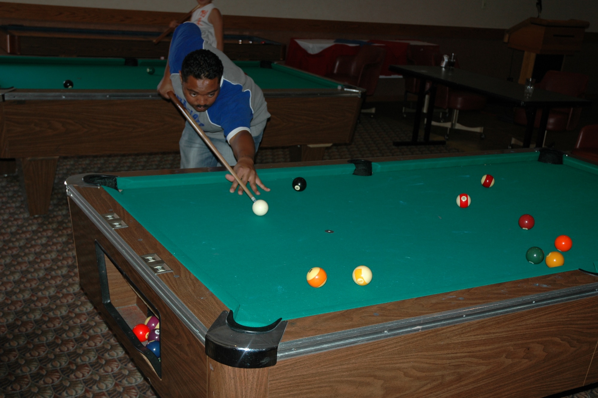 Tech. Sgt. Terence Brown, 21st Space Control Squadron, plays a game of billiards at The Club during Sports and Field Day June 14. Sergeant Brown won the game. (U.S. Air Force photo by Matthew Cook)