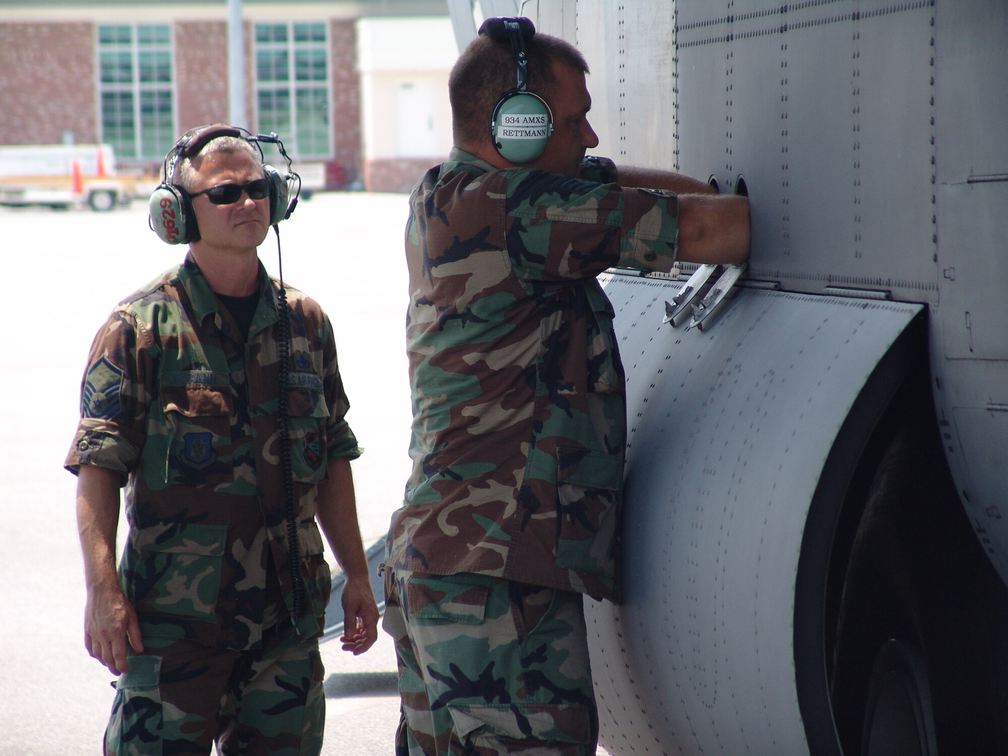 Master Sgt. Al McCann, 934th Aircraft Maintenance Squadron guidance and control technician, watches Tech. Sgt. Ben Rettman check the fluid levels of the C-130 after landing at the Augusta Regional Airport - Bush Field, Ga., in support of the Golden Medic Exercise 2007. The 934th Aircraft Maintenance Squadron is based out of the Minneapolis-St. Paul International Airport Air Reserve Station, Minn.