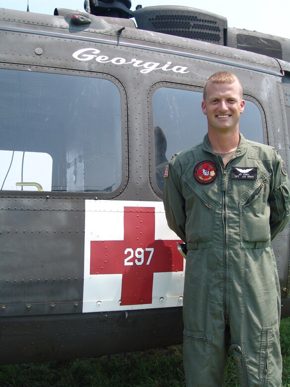 U.S. Army Capt. J.D. Crill, 832nd Medical Company Air Ambulance Detachment 1 commander, stands next to UH-1 helicopter 297 of the Georgia Army National Guard, during the Golden Medic Exercise 2007 at the Augusta Regional Airport - Bush Field, Ga.