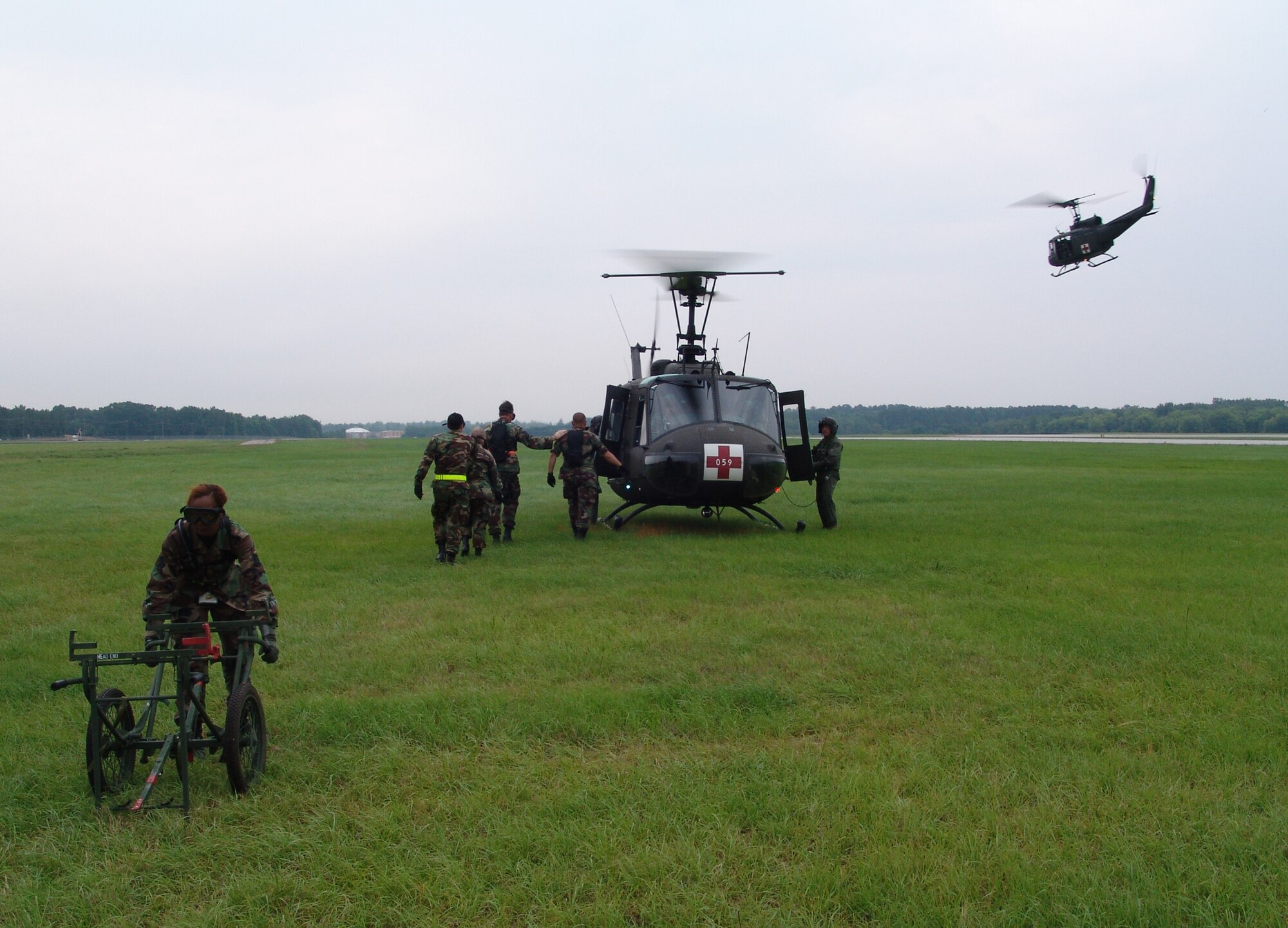 Members of the 706th Provisional contingency aeromedical support facility prepare to off-load patients from a U.S. Army UH-1 Huey helicopter from the 832nd Medical Company Air Ambulance Detachment, during Golden Medic 2007 at the Augusta Regional Airport - Bush Field, Ga.