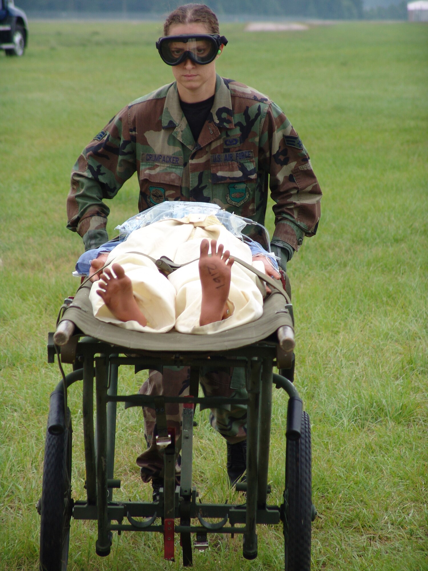 Senior Airman Faith Crumpacker, 932nd Aeromedical Staging Squadron, Scott Air Force Base, Ill., pushes a litter from a helicopter to the contingency aeromedical support facility at the Augusta Regional Airport - Bush Field, during the Golden Medic Exercise 2007.