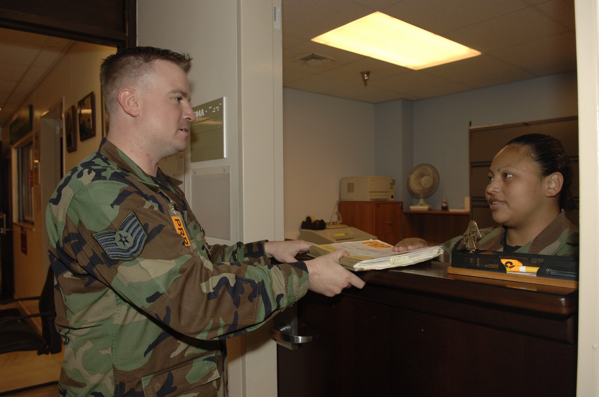 Staff Sgt. Sandra Rivera, 39th Medical Group non-commissioned officer in charge of personnel reliability program records, helps Tech. Sgt. Todd Geisler with his records on June 12. Only those personnel who have demonstrated the highest degree of individual reliability for allegiance, trustworthiness, conduct, behavior and responsibility are allowed to perform PRP regulated duties. (U.S. Air Force photo by Airman 1st Class Tiffany Colburn)