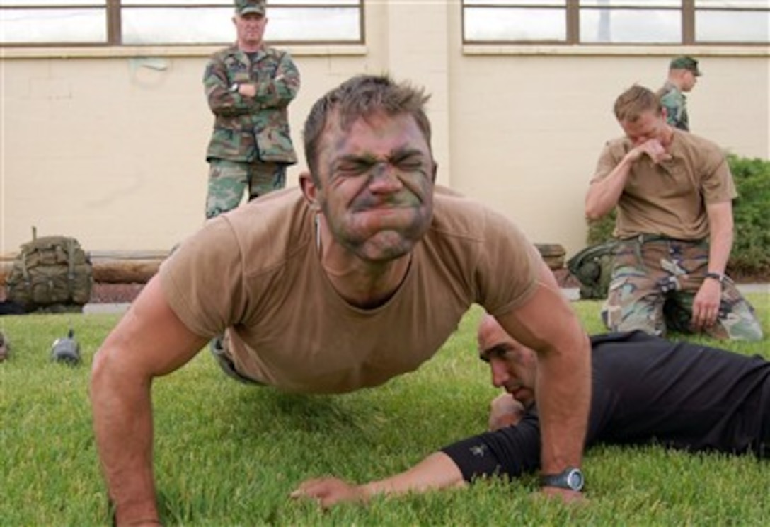 Staff Sgt. Matthew Zimmer pumps out as many push-ups as he can during the physical fitness portion of the Survival, Evasion, Resistance and Escape Challenge June 13 at Fairchild Air Force Base, Wash.