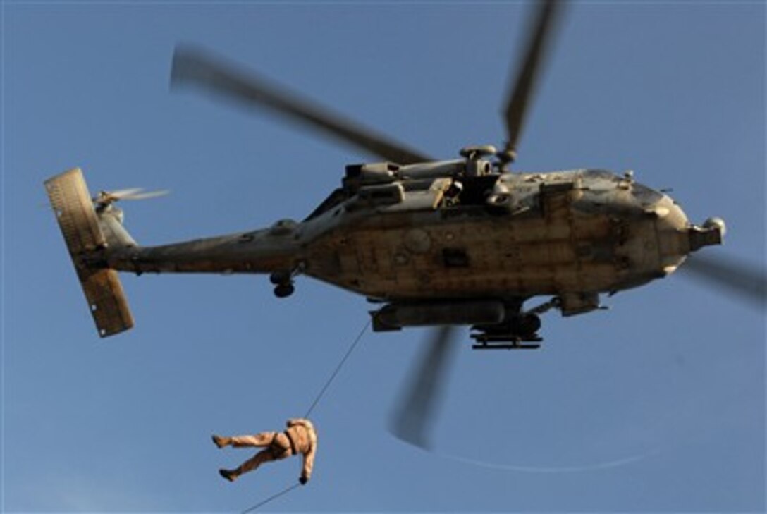 U.S. Navy Petty Officer 1st Class Geno Jahrling rappels from an HH-60H Seahawk helicopter to the deck of the USS Bonhomme Richard (LHD 6) during under way exercises in the Persian Gulf on June 6, 2007.  The Bonhomme Richard Expeditionary Strike Group is participating in expeditionary strike force exercises with the John C. Stennis and Nimitz Carrier Strike Groups.  