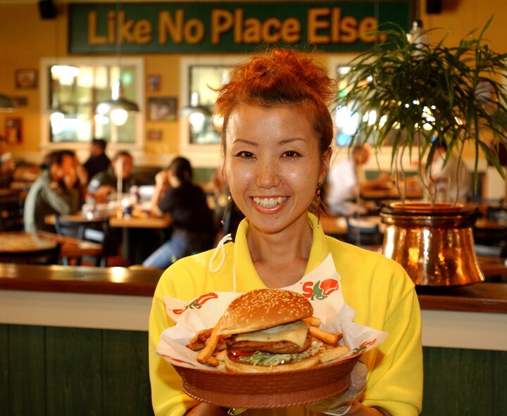 KADENA AIR BASE, Japan -- Mami Andrew, a Chili's Too employee, shows one of the restaurant's main dishes. Chili's Too is a smaller scale restaurant serving the same quality of food as the main restaurant, but faster. The restaurant opened here June 18 and is one of the busiest Chili's restaurants in the world.  (U.S. Air Force photo by Staff Sgt. Reynaldo Ramon)

