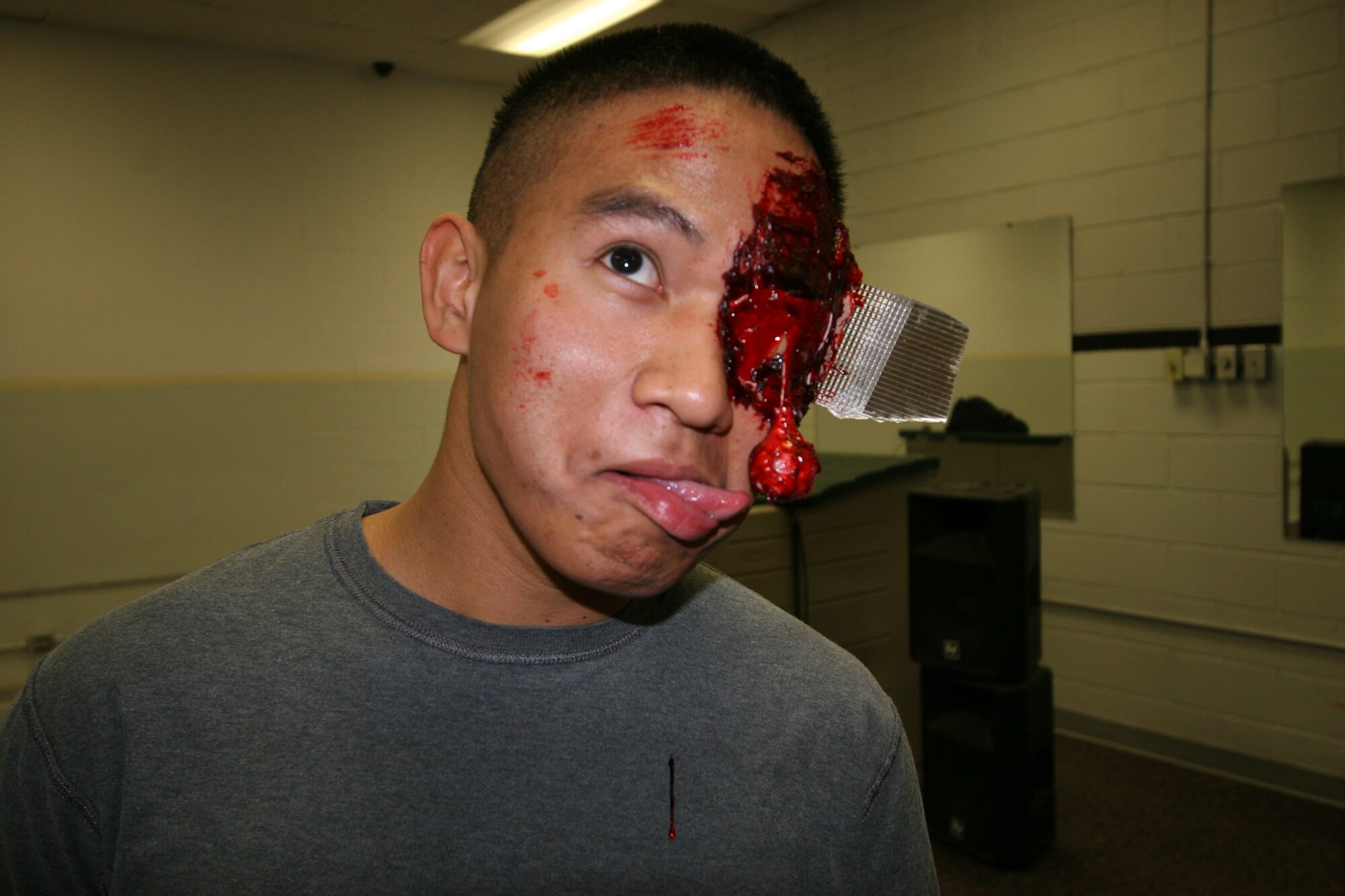 HILL AIR FORCE BASE, Utah--Despite his gory appearance, Senior Airman Ivan Ferrer, 75th Medical Support Squadron, has some fun with being a moulage vicitim. (U.S. Air Force photo by Beth Young)