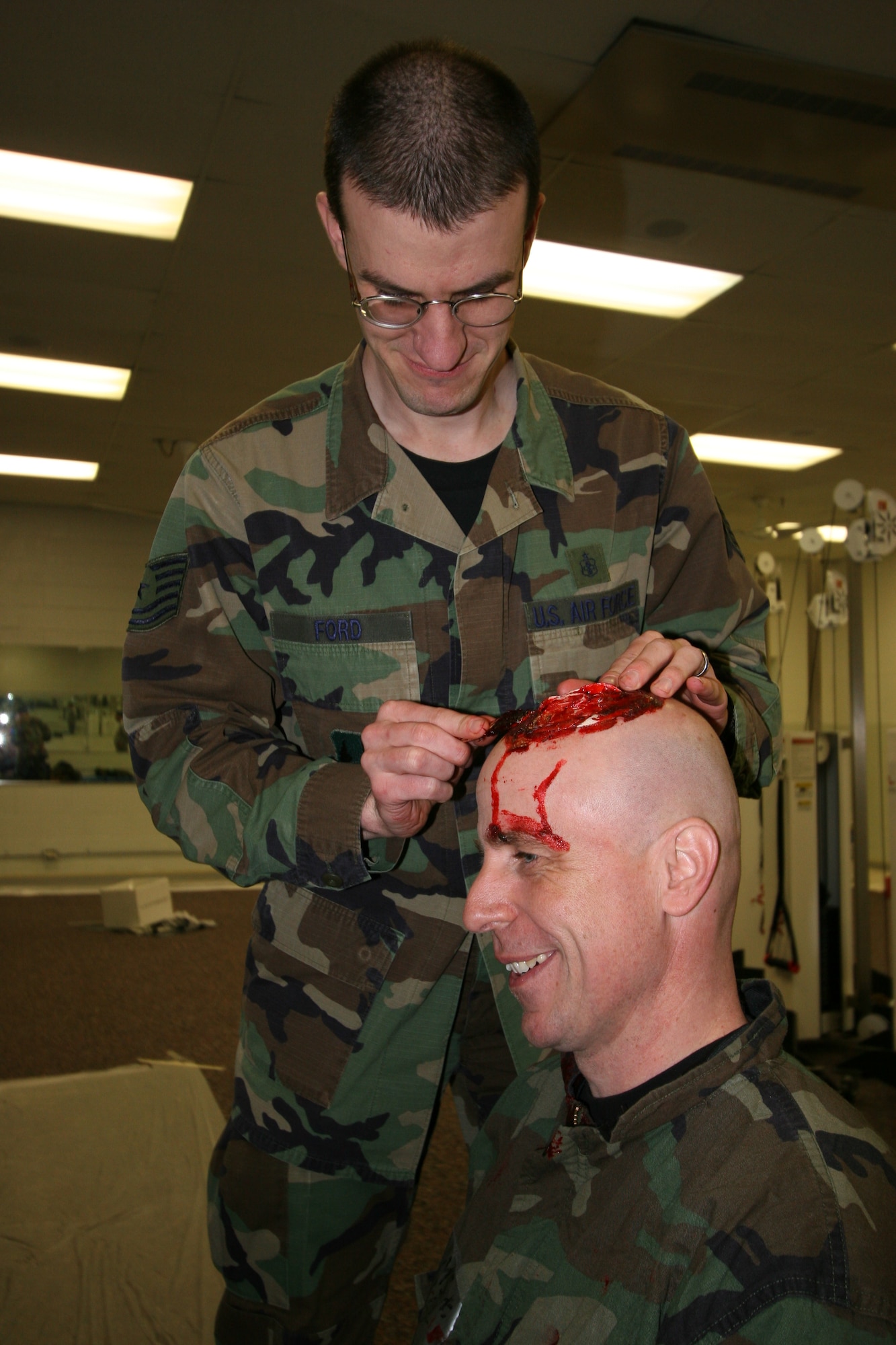 Tech. Sgt. John Ford, 75th Medical Group, creates a head wound on Capt. Michael Alfaro, 75th Dental Squadron, for a readiness exercise held in March. (U.S. Air Force photo by Beth Young)