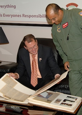 Dave Pelzer, New York Times best selling author and former Air Force boom operator, and Master Sgt. Jose Martinez, 350th Air Refueling Squadron, look at a squadron photo album during Mr. Pelzer’s visit to McConnell June 15. The author came to McConnell to talk to wing personnel and their families about leadership and person responsibility. During Mr. Pelzer’s visit, the 22nd ARW chief’s group also made him an honorary chief master sergeant. (Photo by Airman 1st Class Laura Suttles)
