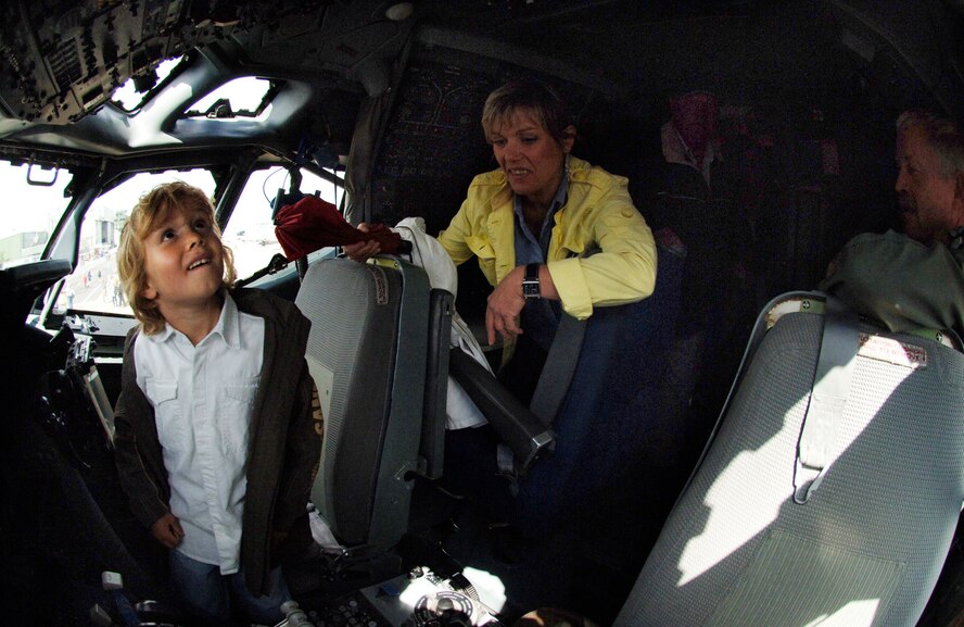 Six-year-old Noah Kranz and his mother, Heidi, tour the cockpit of a NATO E-3 Airborne Early Warning and Control Force aircraft June 16 at Geilenkirchen NATO Air Base, Germany. The civilians were among several thousand local citizens who attended a 25th anniversary celebration of the aircraft's initial operations at the NATO base in northern Germany. (U.S. Air Force photo/Master Sgt. Scott Wagers)