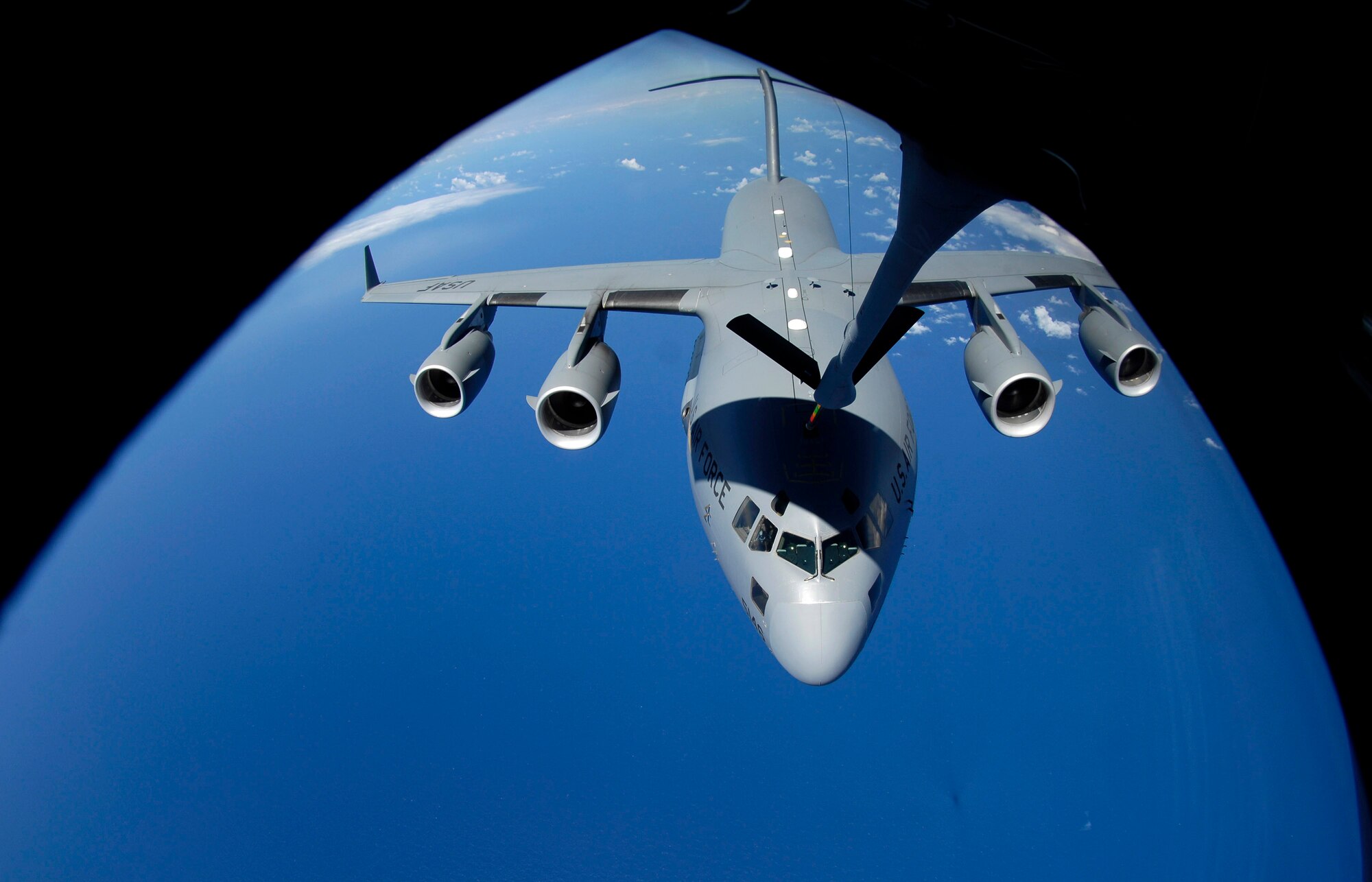 A C-17 Globemaster III receives fuel from a KC-135 Stratotanker June 18 during aerial refueling. The 909th Air Refueling Squadron came from Kadena Air Base, Japan to Hickam Air Force Base, Hawaii, to practice refueling with the 535th Airlift Squadron for the Air Mobility Command Rodeo. (U.S. Air Force photo/Tech. Sgt. Shane A. Cuomo)
