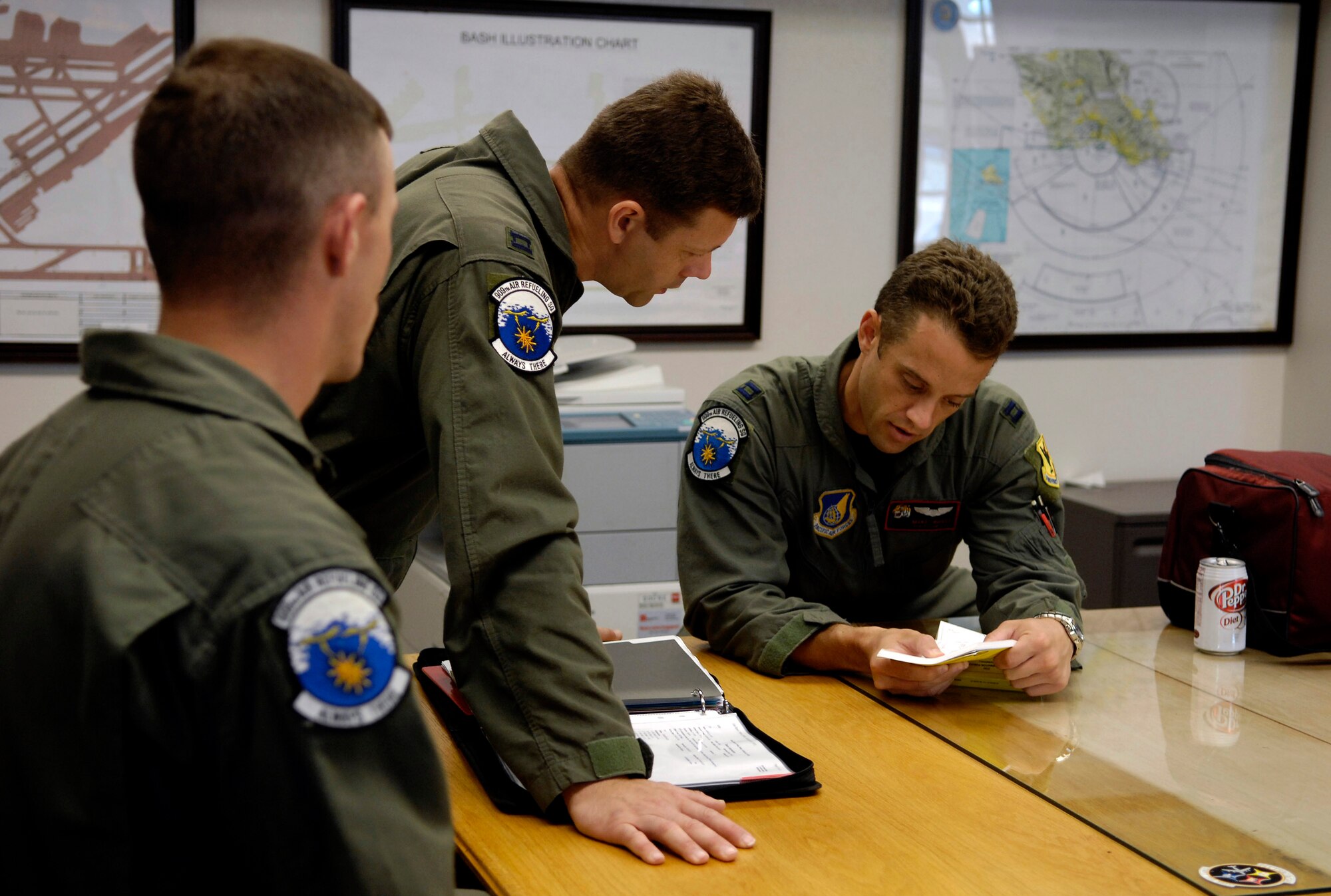 C-17 Globemaster III aircrew members conduct a flight briefing prior to departing June 18 on a refueling training mission at Hickam Air Force Base, Hawaii. A KC-135 Stratotanker from the 18th Wing at Kadena Air Base, Japan is at Hickam AFB practicing with a Globemaster crew from the 535th Airlift Squadron for the Air Mobility Command Rodeo. The Airmen are with the 909th Air Refueling Squadron. (U.S. Air Force photo/Tech. Sgt. Shane A. Cuomo) 