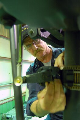 Gary Langstaff completes a pre-flight maintenance inspection on the main rotor assembly of a UH-1N "Huey" helicopter assigned to the 36th Rescue Flight based at Fairchild Air Force Base, Wash.  Mr. Langstaff, who served 10 years as a UH-1 crew chief in the U.S. Army, is contracted through Sikorsky Support Services, Inc. to provide on-site maintenance service for the flight's missions.  (U.S. Air Force photo by Staff Sgt. Matthew Rosine)