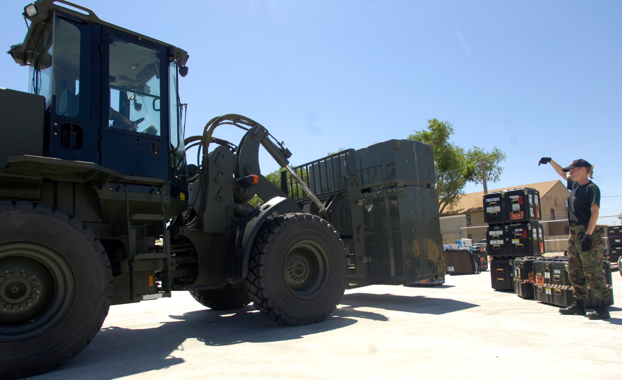 MOUNTAIN HOME AIR FORCE BASE, Idaho -- Master Sgt. Annette Miller, 366th Communications Squadron, directs equipment placement during a pallet loading operation as part of the first phase of exercise Sharpshooter 07-02 June 21. The Air Expeditionary Force Communications Element has 36 hours to pack classified and unclassified equipment to support deployed email and phone services after getting a deployment order. (U.S. Air Force photo/Airman 1st Class Ryan Crane)