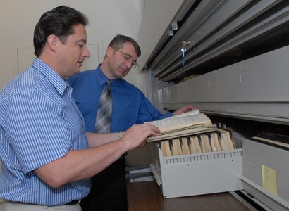 Pete Law (left) and Lane Bourgeois, 12th Flying Training Wing historians, review information from the office’s history repository. (U.S. Air Force photo by Rich McFadden)