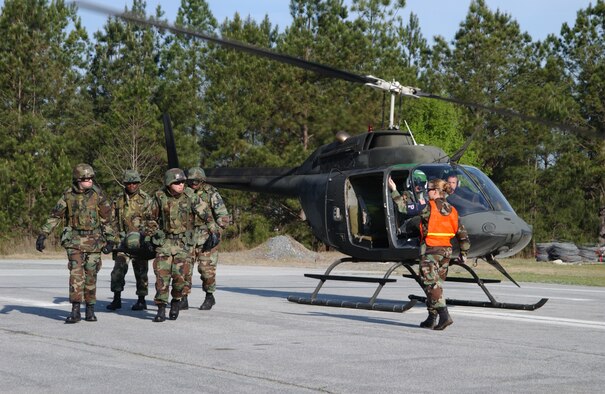Staff Sgt. Genis Membrila, an instructor in the 78th Security Forces Squadron, leads a team of students safely away from a helicopter. (Courtesy photo)