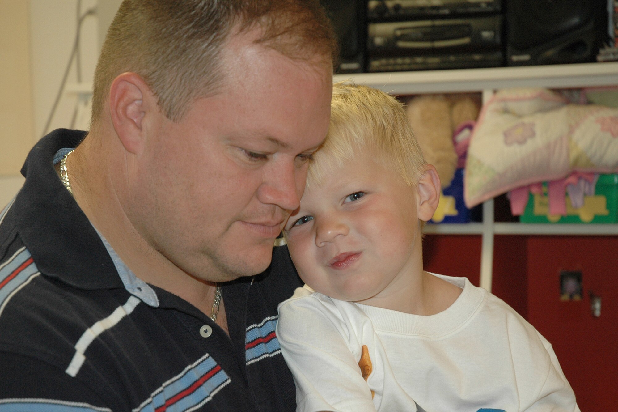 Senior Master Sgt. Dennis Struve, 18th Air Refueling Squadron, and his son Parker, 3, share some bonding time during the annual Father’s Day breakfast at the McConnell Child Development Center, June 15. (Photo by Tech. Sgt. Genevieve Morris)