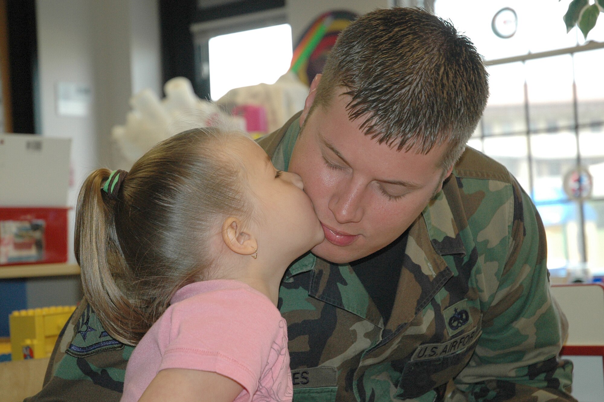 Matthew Reeves, 22nd Aircraft Maintenance Squadron, receives a kiss from his daughter, Kayla, 4, during the annual Father’s Day breakfast at the McConnell Child Development Center, June 15. (Photo by Tech. Sgt. Genevieve Morris)