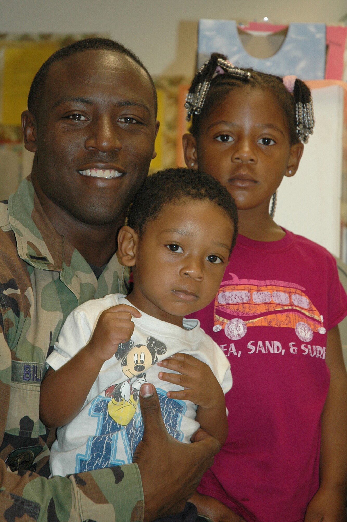 First Lt. Antoine Bills, 22nd Logistics Readiness Squadron, and his children, L.J., 1 and Ahmiya, 4, enjoy the annual Father’s Day breakfast at the McConnell Child Development Center, June 15. 