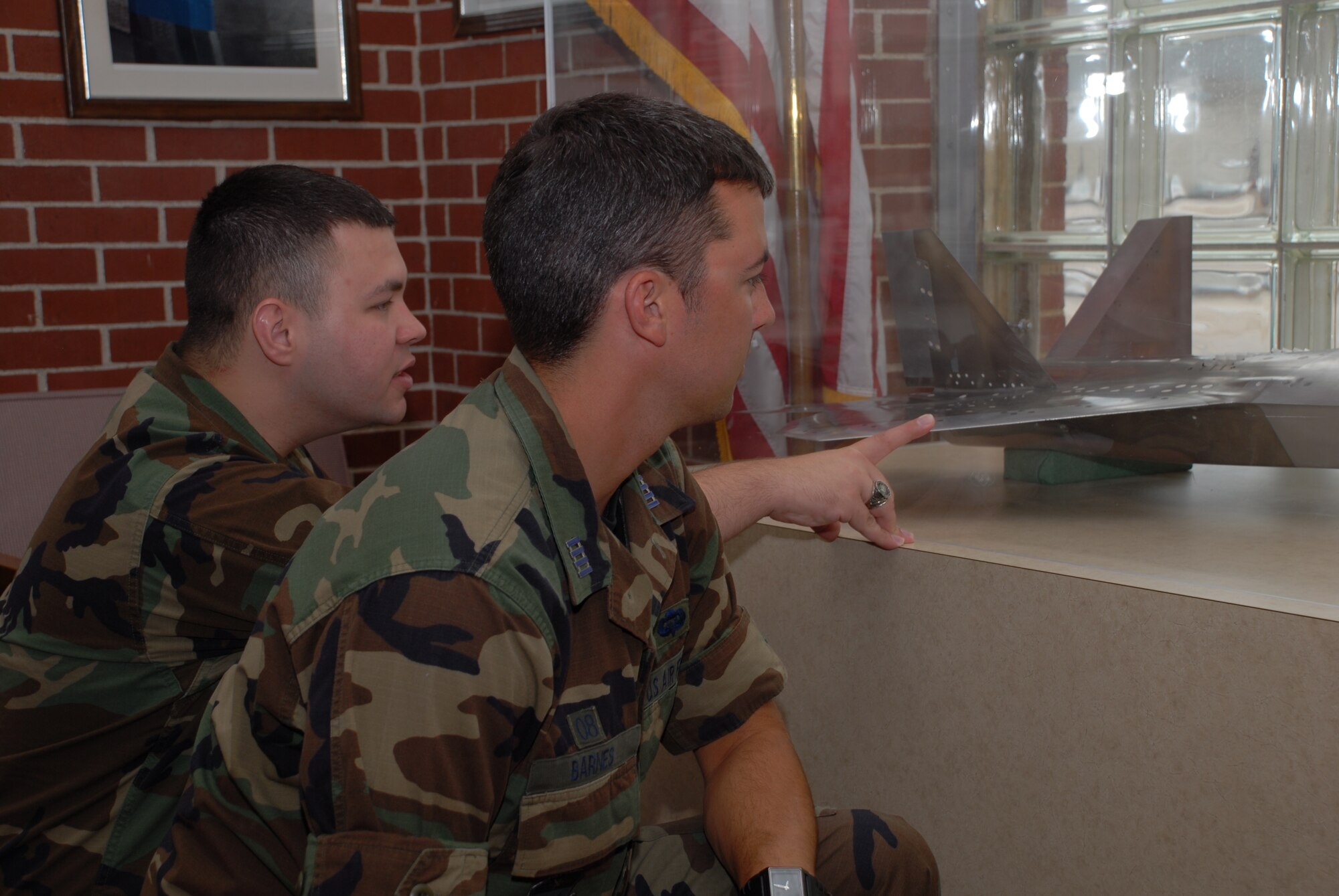 1st Lt. David Cancel tells Cadet Remington Barnes about the 1-1/15 scale model of the F-22A Raptor that sits in the Propulsion Wind Tunnel Facility Lobby. (Photo by Rick Goodfriend)