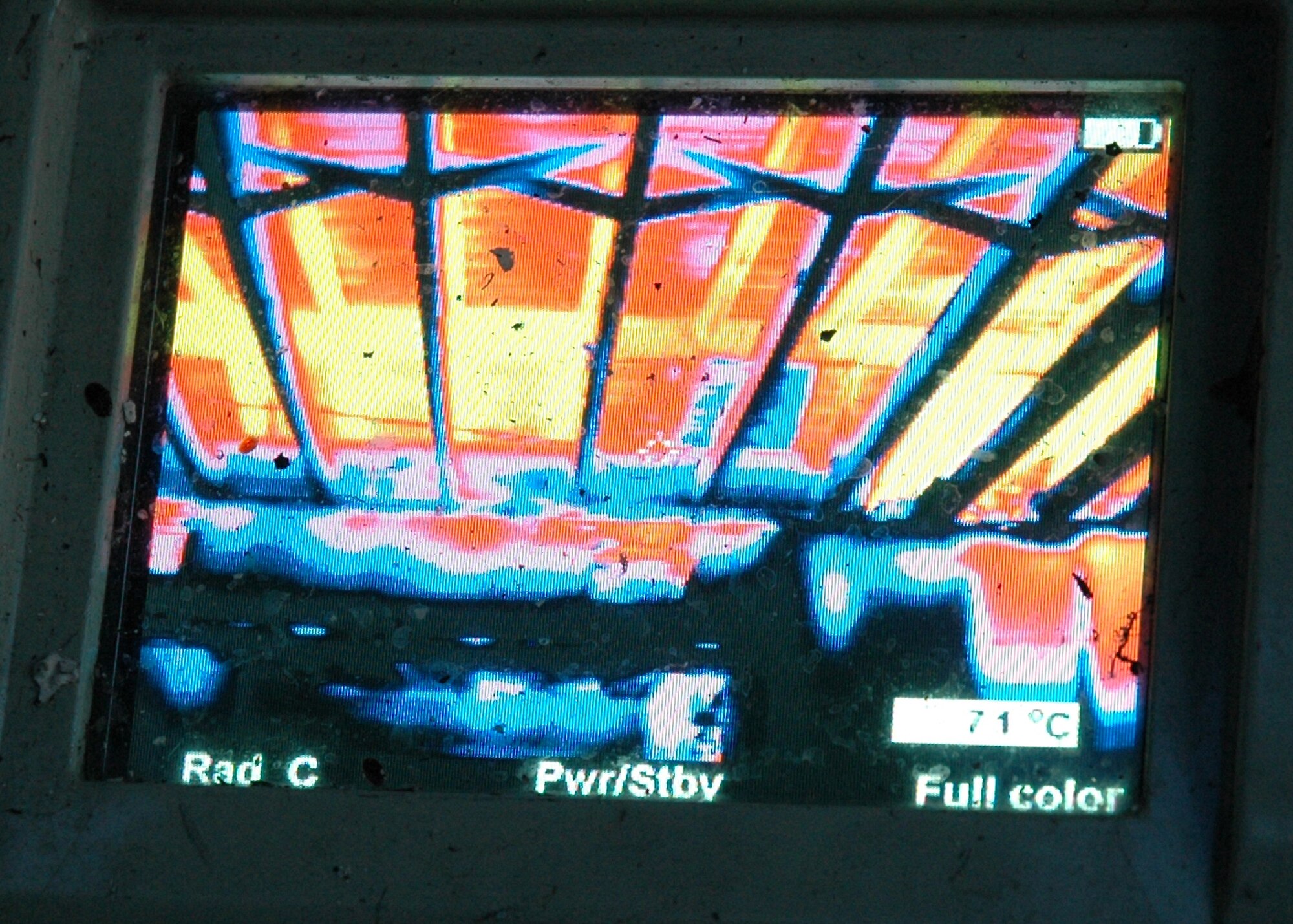 EGLIN AIR FORCE BASE, Fla. -- A firefighter with the 96th Civil Engineer Squadron Fire Department uses a thermal imaging camera to see through the smoke to see where the hot spots are in a fire and to keep track of the crew June 20. The camera helps firefighters see where they are going in situations where smoke creates zero visibility conditions. Eglin firefighters experienced the flames in a controlled scenario, part of a unique "real fire" training opportunity. Houses along Foster Drive, slated for demolition as part of Eglin?s housing privatization initiative, were used for the training. (U.S. Air Force photo by Staff Sgt. Mike Meares)