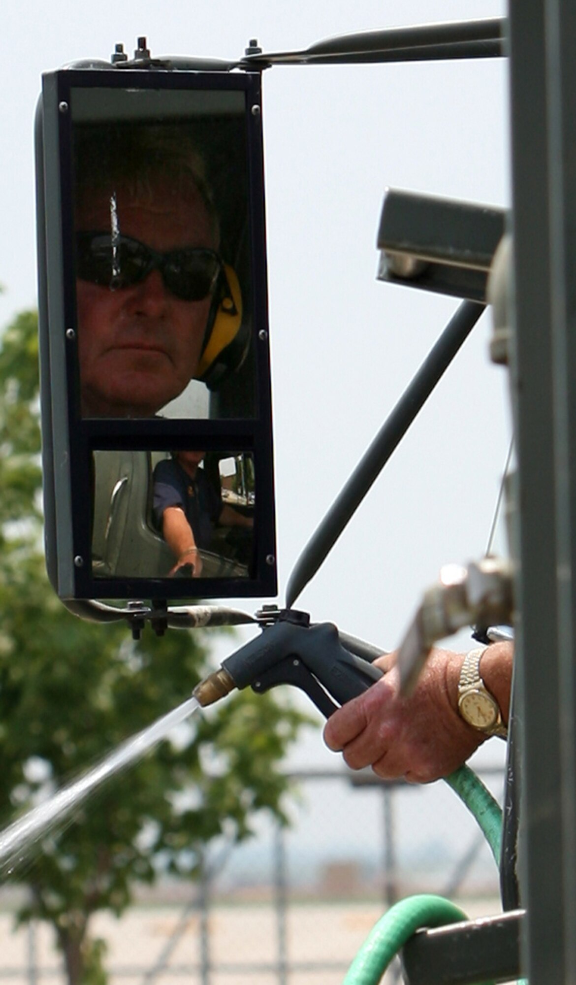 GRISSOM AIR RESERVE BASE, Ind. -- Marvin Plunkett, a grounds maintainer with Satellite Services Inc., waters one of the trees at Grissom.. Along with receiving many Department of Defense awards for environmental excellence, Grissom has been designated a "Tree City" by the National Arbor Day Foundation. (U.S. Air Force photo/Senior Airman Omar Delacruz)