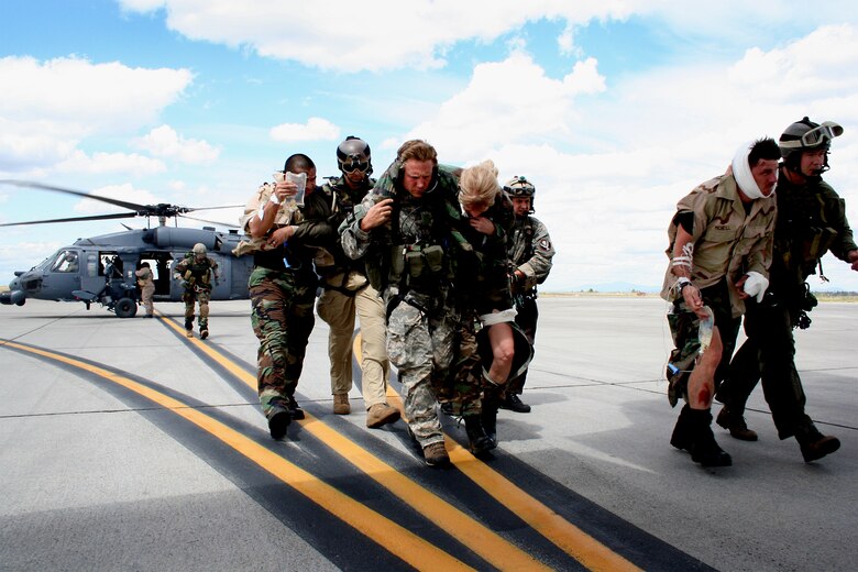 FAIRCHILD AIR FORCE BASE, Wash. -- Reservists from the 943rd Rescue Group, Davis-Monthan Air Force Base, Ariz., and the 304th Rescue Squadron, Portlant IAP, Ore., transfer mock casualties from their HH-60G Pave Hawk to a waiting C-130. The pararescue units teamed up for Patriot Angel, a Combat Search and Rescue exercise held here June 13 - 21. (U.S. Air Force photo/Staff Sgt. Paul Flipse) 