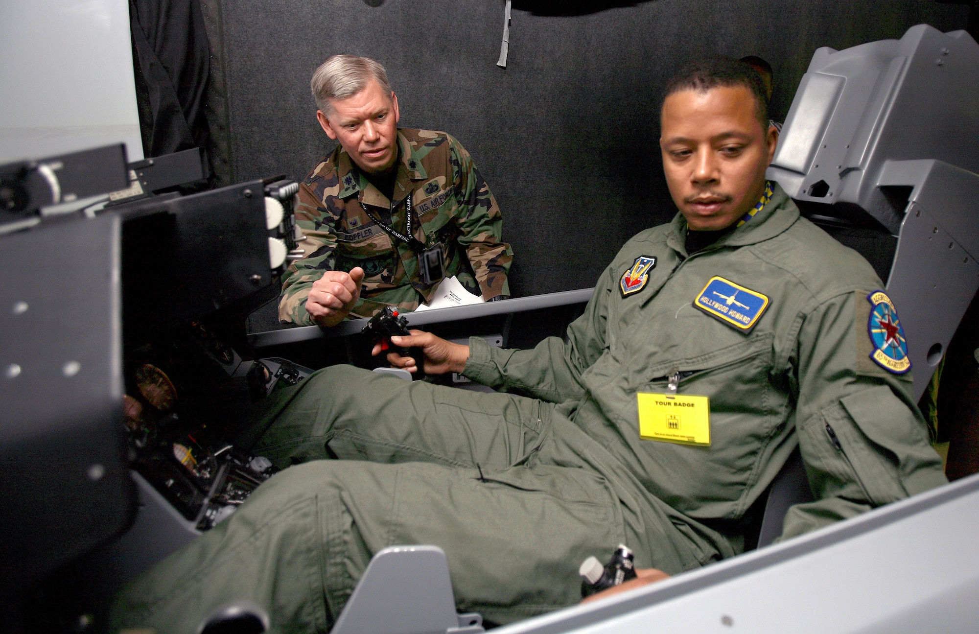 Lt. Col. David Coppler instructs actor Terrence Howard on the controls of an F-16 Fighting Falcon simulator at Edwards Air Force Base, Calif., to help prepare Howard for his role in the movie, "Iron Man." Movie director Jon Favreau and his crew spent three days filming at Edwards AFB. Colonel Coppler is the 772nd Test Squadron commander. (U.S. Air Force photo/Jet Fabara)