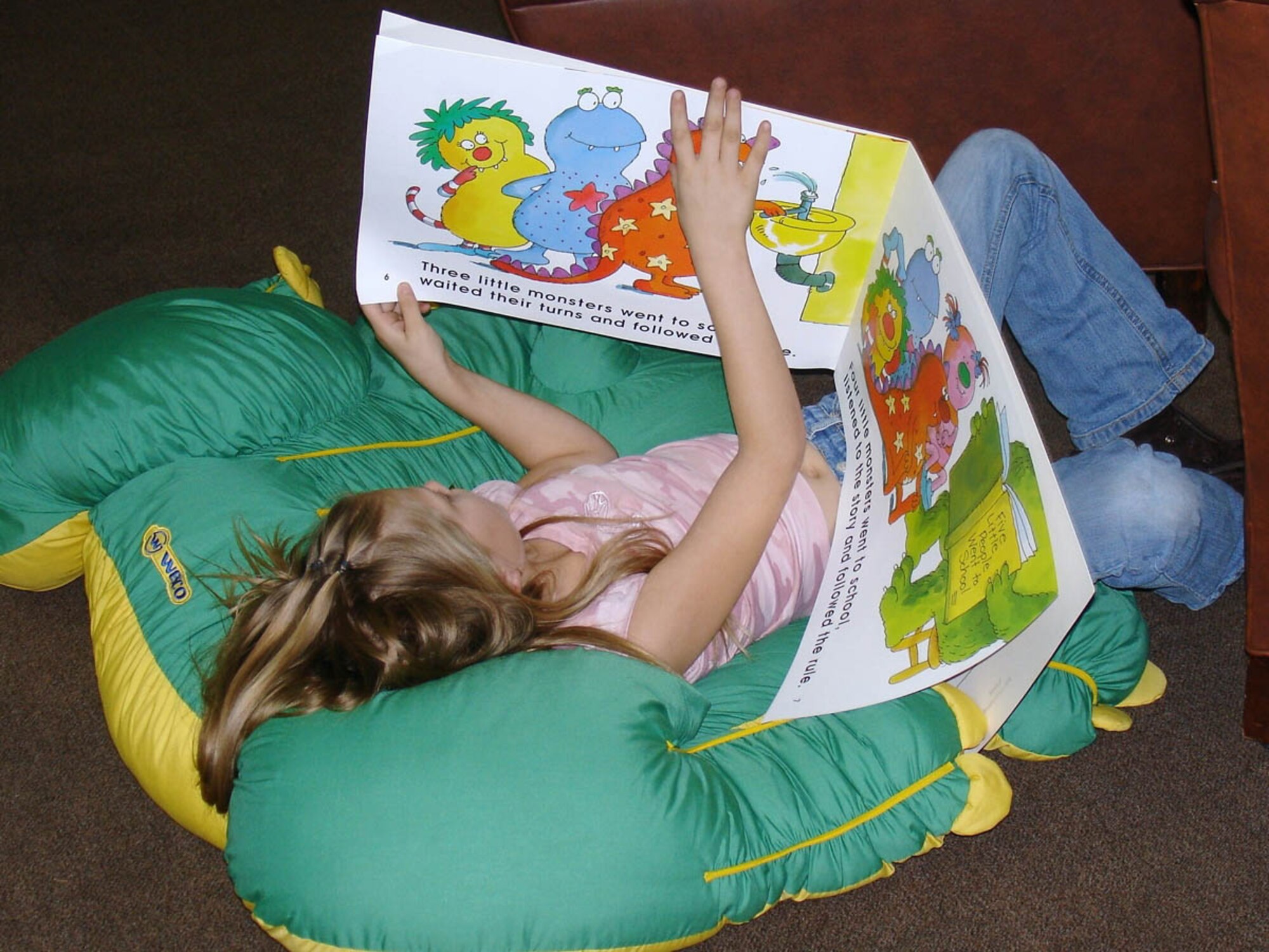 SPANGDAHLEM AIR BASE, GERMANY -- A Spangdahlem Elementary School student gets comfortable with a library book. Department of Defense Dependents Schools-Europe’s Spangdahlem Elementary School was awarded a $5,000 grant by the Laura Bush Foundation for America’s libraries. Spangdahlem is one of 263 schools to benefit from $1.28 million in support from the foundation, and the only school outside the geographic boundaries of United States to be so awarded.
(Photo by Willow Torres)