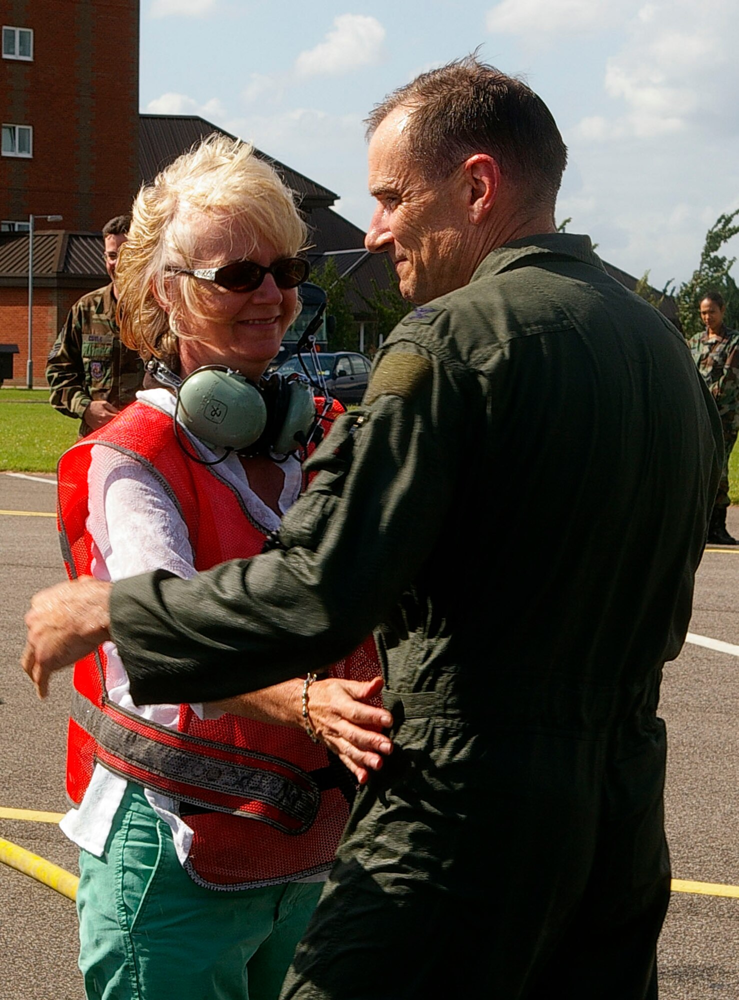 Col. Michael S. Stough, 100th Air Refueling Wing commander, gets a congratulatory hug from his wife, Tracey, following his fini flight here June 20. (U.S. Air Force photo by Karen Abeyasekere)