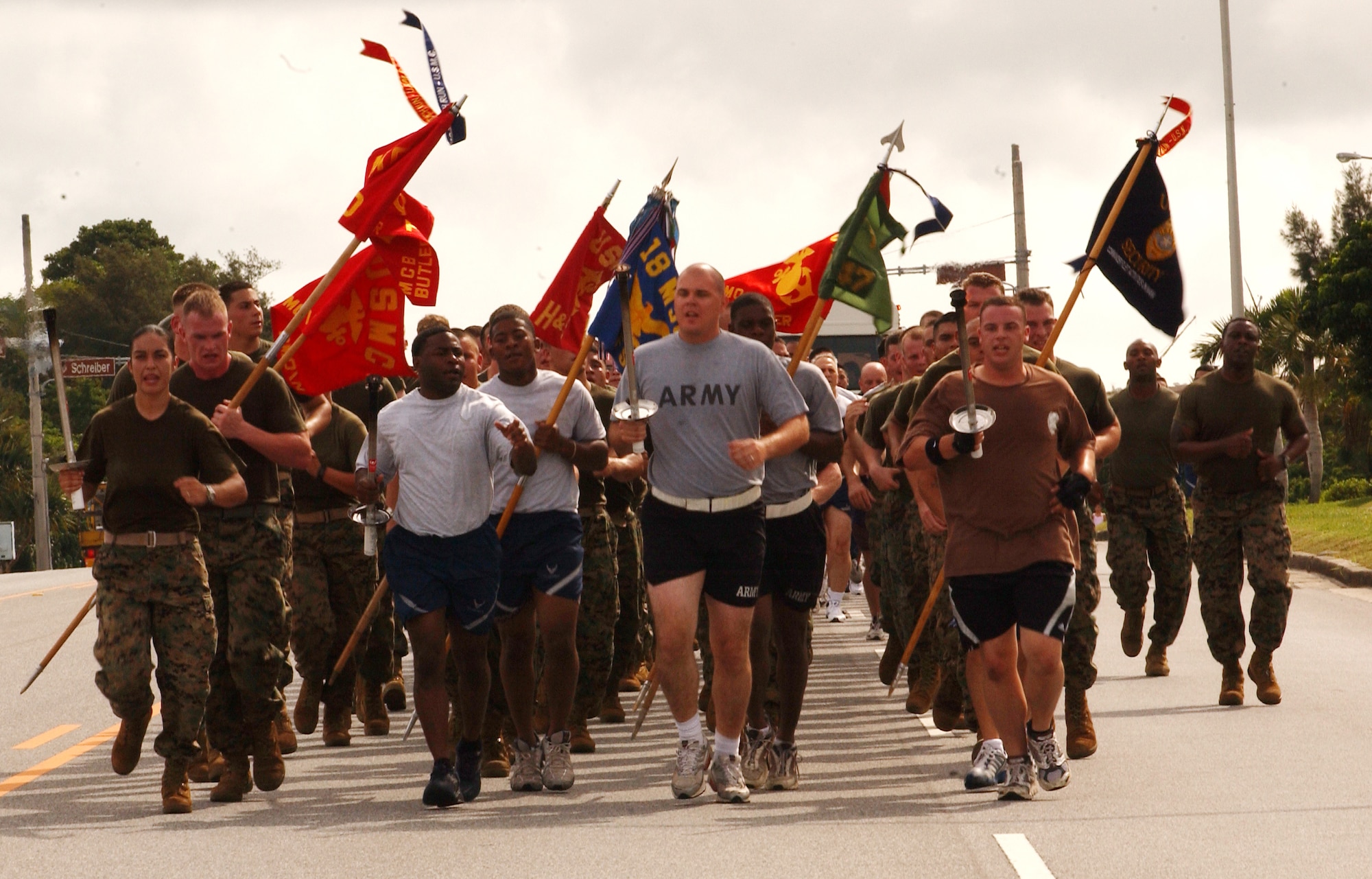 All four services run together for the Law Enforcement Torch Run from Bldg. 705 to the Risner gym at Kadena Air Base, Japan, June 16. The Torch Run is affiliated with Special Olympics nation wide and was adopted at Kadena to promote awareness for the annual event here. (U.S. Air Force photo by Staff Sgt. Reynaldo Ramon)