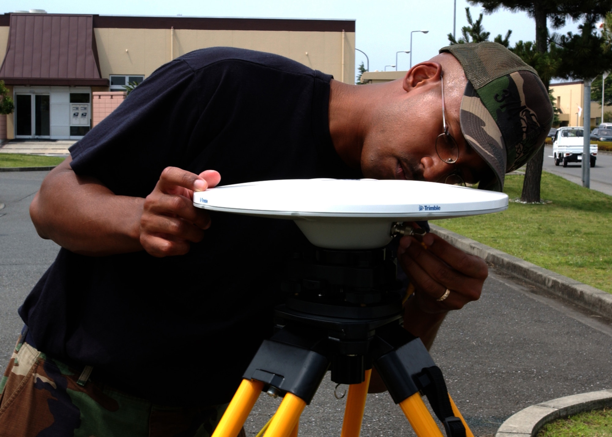 YOKOTA AIR BASE, JAPAN -- Staff Sergeant Kevin Howell, from the 374th Civil Engineer Squadron, screws in wiring while setting up Global Positioning Statellite (GPS) equipment on June 21, 2007.  The equipment is designed to transmit GPS mapping data to satellites in order to improve existing satellite maps. (U.S. Air Force photo by Airman First Class Jonathan Fowler)                               