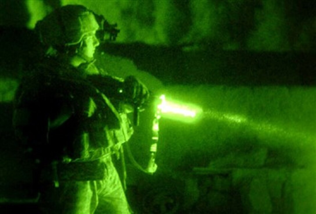 A Stryker soldier with Company B, 4th Battalion, 9th Infantry Regiment, pulls security during the clearing of a village in the outskirts of Baqouba, Iraq, as part of Operation Arrowhead Ripper, June 19.