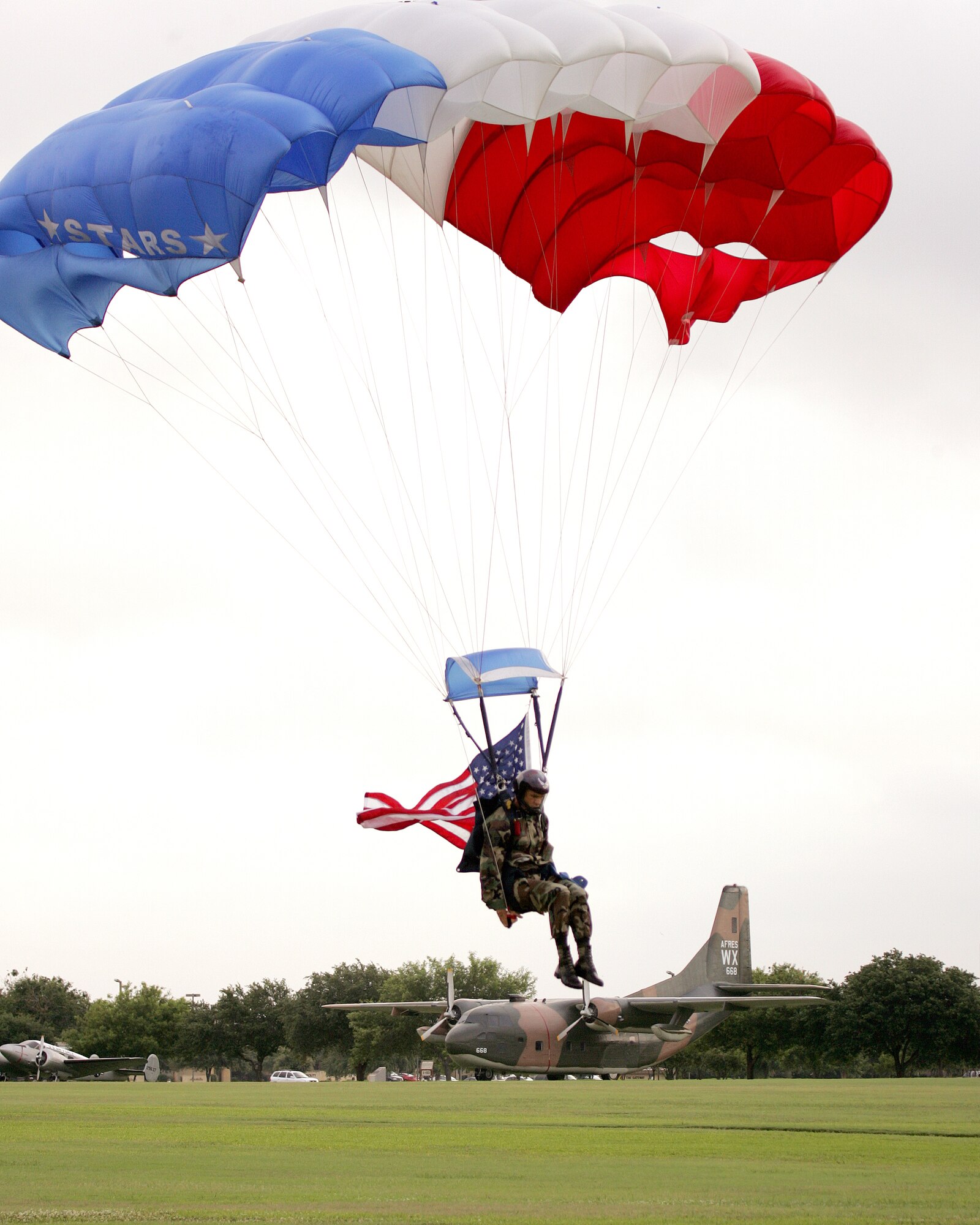 Airmen from the 342nd Training Squadron's pararescue and combat control instructor staff jump into the memorial ceremony June 18 as a tribute to Special Agent Matthew Kuglics' close working relationship with the Air Force Special Operations community. Agent Kuglics was killed in action by an improvised explosive while supporting Operation Iraqi Freedom. (U.S. Air Force photo/Robbin Cresswell)