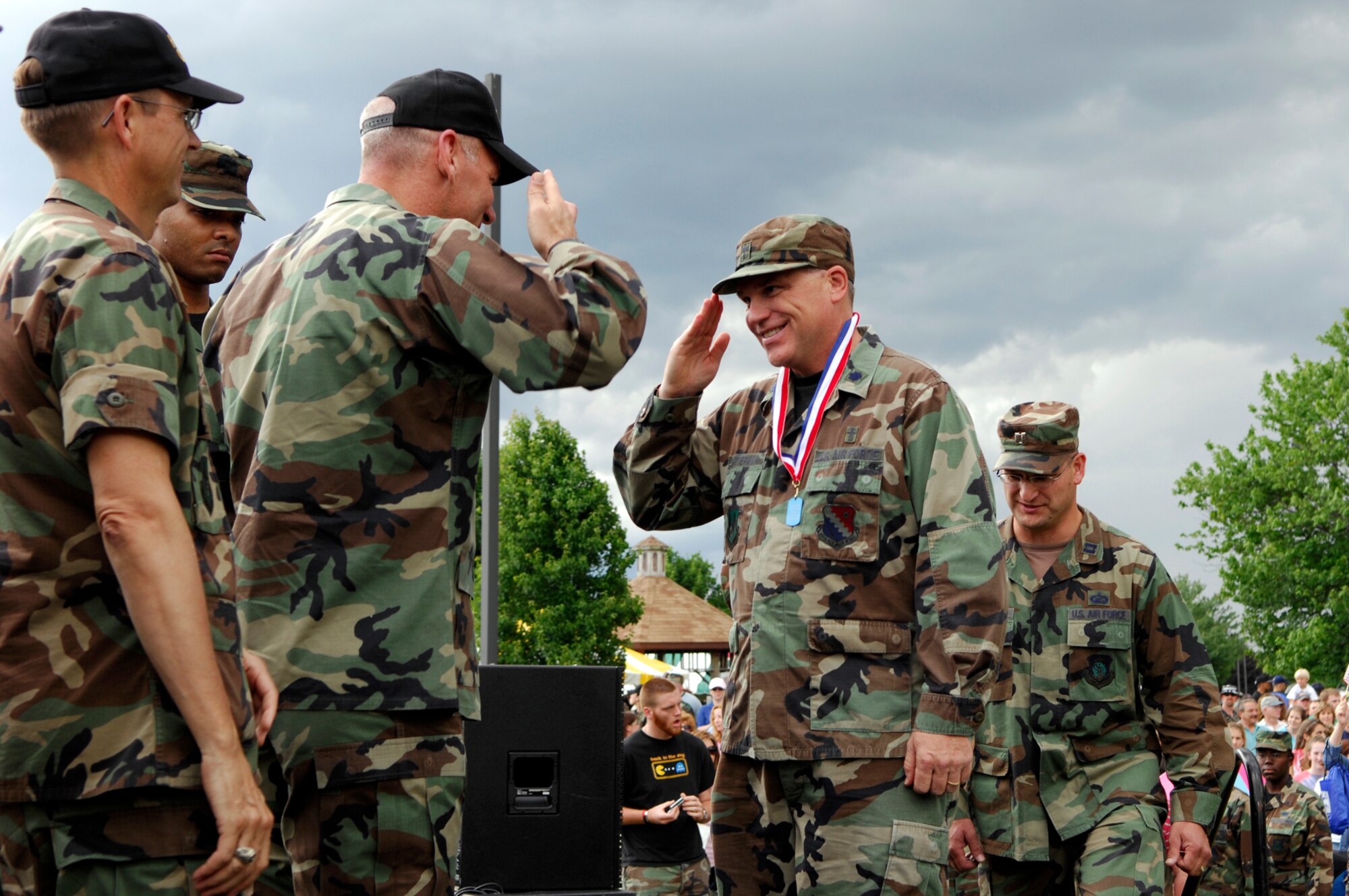 Lt. Col. Dennis Kitterman, Wing Chaplain for the 66th Air Base Wing, receives a medallion from Col. Tom Schluckebier, 66 ABW commander, during Hanscom’s Heroes’ Homecoming event held June 22. (Far left) Col. Bob ONeill, Electronic Systems Center chief of staff, was one of several base leaders to shake hands with the deployers. During the event, over 60 servicemember who had deployed within the last 6 months were formally welcomed home and recognized for their service. (US photo by Mark Wyatt)