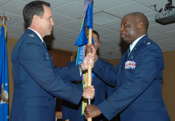 Lt. Col. Frederick H. Grantham (right) receives the 355th Medical Support Squadron guidon from 355th Medical Group Commander Col. Scott W. Van Valkenburg at the Mirage Officers' Club here June 22. (U.S. Air Force photo/Airman 1st Class Noah R. Johnson)