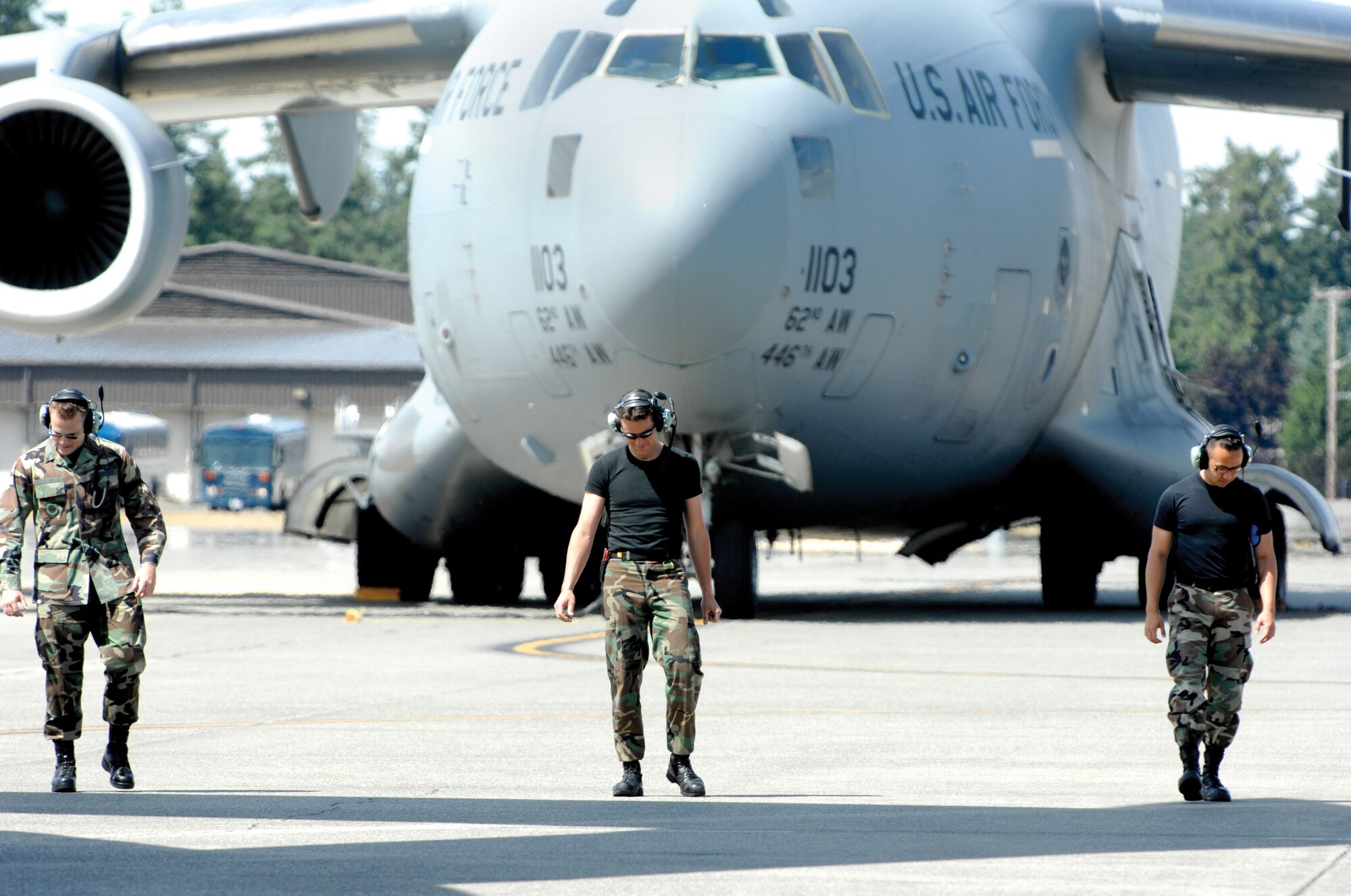 MCCHORD AIR FORCE BASE, Wash. -- Members of the 62nd Aircraft Maintenance Squadron Rodeo team, from left, 1st Lt. John Barry, Tech. Sgt. Ronald Garbarini and Staff Sgt. Zachary Hoene scan the flightline for foreign debris during a post flight inspection on June 12.  (U.S. Air Force photo/Abner Guzman)