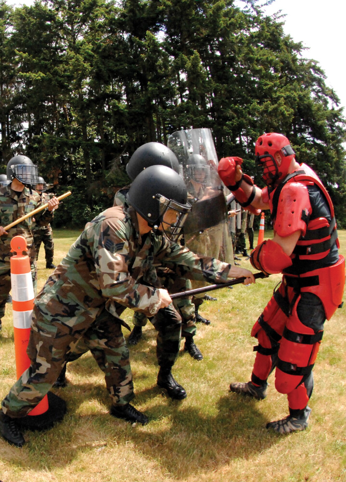 MCCHORD AIR FORCE BASE, Wash. -- Staff Sgt. Joseph Pinkham, 62nd Logistics Readiness Squadron, dressed in protective gear, antagonizes a group of security forces Airmen while role-playing as one of 25 angry protesters during a civil-disturbance training session on base, June 14.  (U.S. Air Force photo/Abner Guzman