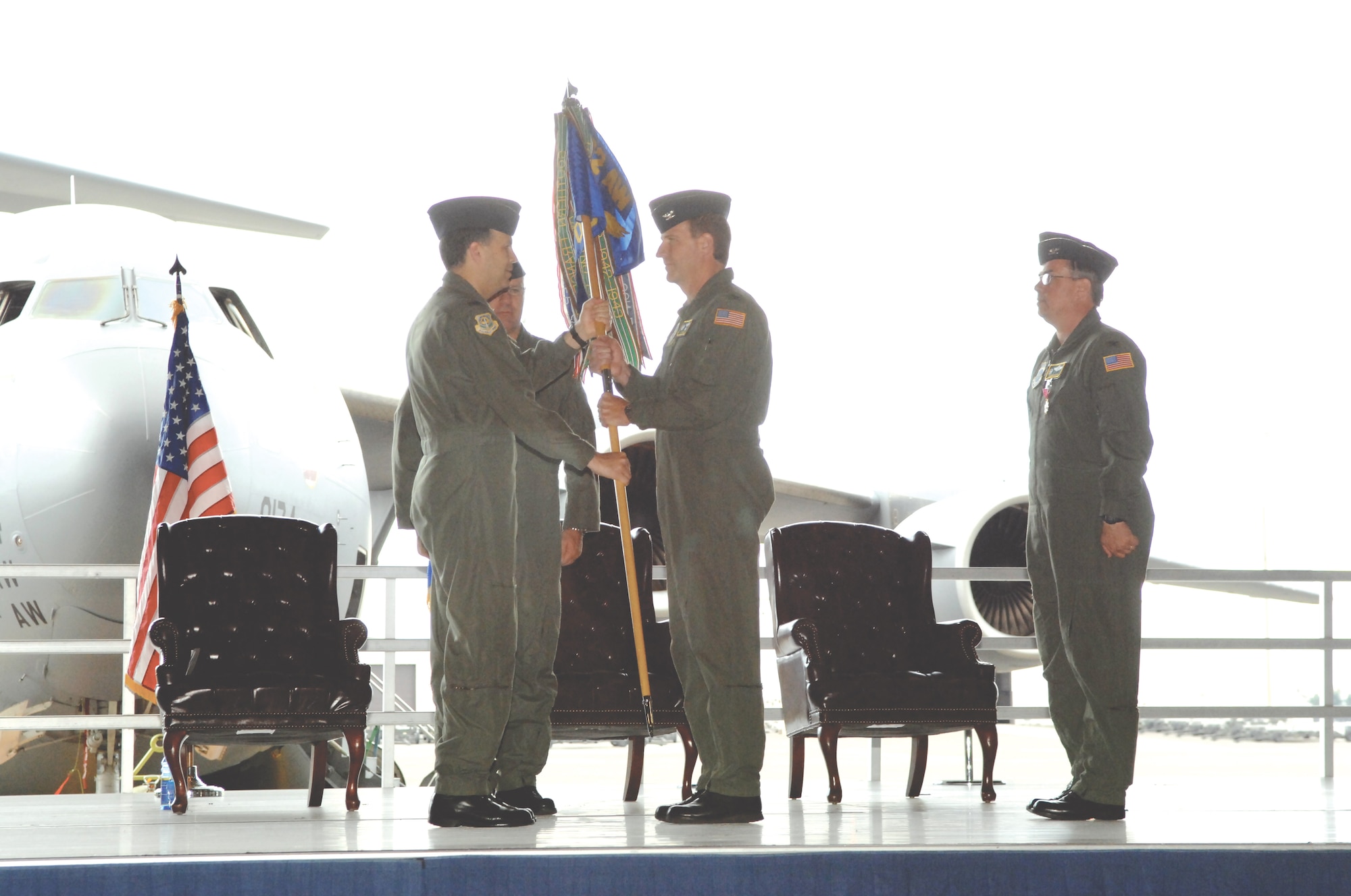 MCCHORD AIR FORCE BASE, Wash. -- Col. Jerry Martinez, left, 62nd Airlift Wing commander, passes command of the 62nd Operations Group to Col. Joe Wiley,  the new 62nd OG commander, during a change-of-command ceremony June 15 in Hangar 1. 
