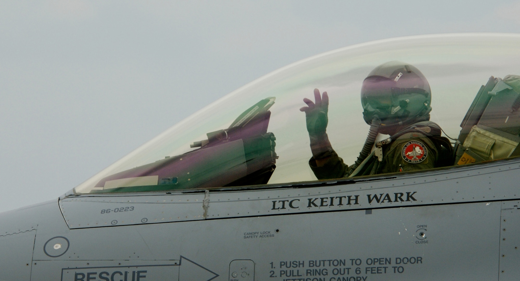 Maj. Mark Mitchum, a pilot with the Virginia Air National Guard's 192nd Fighter Wing, waves as he taxis down the runway prior to flying his last mission in an F-16 Fighting Falcon.  Pilots from the 192nd are transitioning from the F-16 to the F-22 Raptor and belong to the first Air National Guard unit to fly the Raptor. (U.S. Air Force Photo/Staff Sgt. Samuel Rogers)