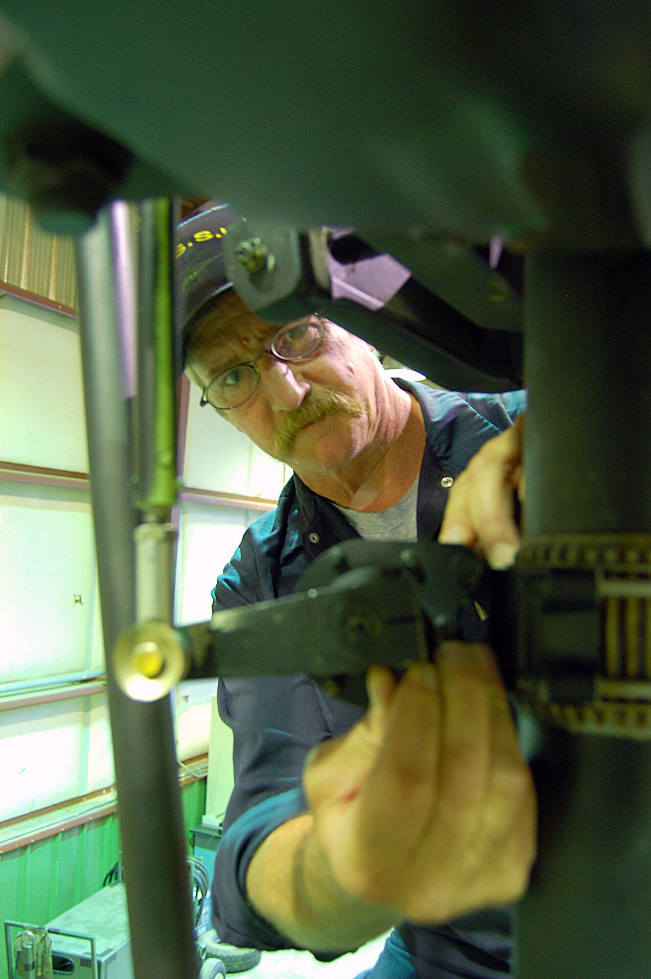 Gary Langstaff completes a pre-flight maintenance inspection on the main rotor assembly of a UH-1N Huey helicopter assigned to the 36th Rescue Flight based at Fairchild Air Force Base, Wash. Mr. Langstaff, who served 10 years as a UH-1 crew chief in the Army, is contracted through Sikorsky Support Services, Inc. to provide on-site maintenance service for the flight's missions. (U.S. Air Force photo/Staff Sgt. Matthew Rosine) 
