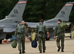 From left: Lt. Col. Mark McCauley, Col. Charles Smith, and Maj. Mark Mitchum, F-16 pilots with the 192nd Virginia Air National Guard Unit in Sandston, Va., step to their respective aircraft  for their final flight  with the wing June 20. For the past two years, the 192nd has been integrating with the 1st Fighter Wing here as part of the Total Force Initiative. Pilots from the 192nd are transitioning from F-16 Falcons to F-22A Raptors and belong to the first Air National Guard Unit to fly the Raptor. (U.S. Air Force Photo/Staff Sgt. Samuel Rogers)