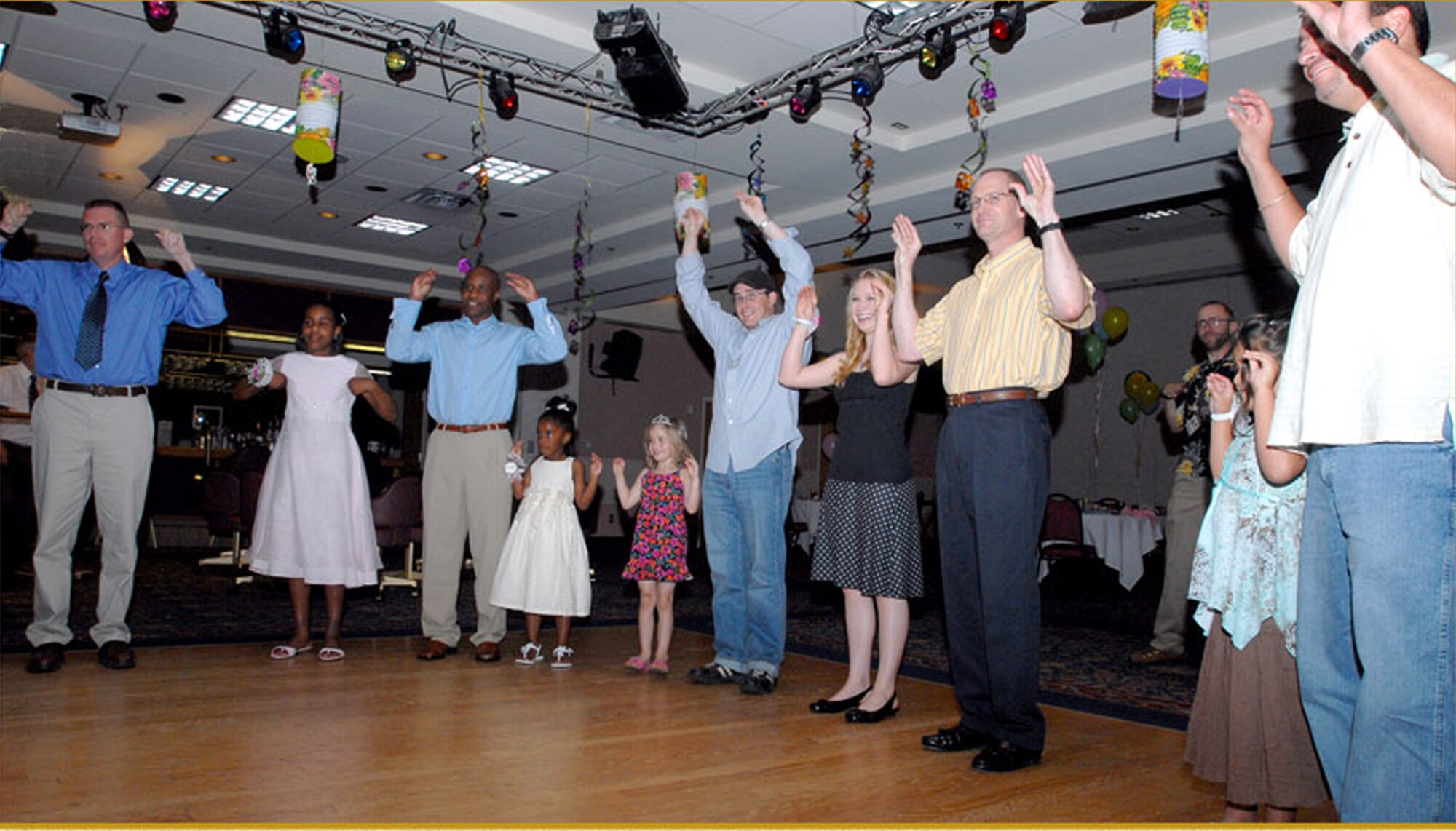 Guests attending the Daddy/Daughter Dance wiggle and shake to the beat of the “Chicken Dance.” (U.S. Air Force photo by Staff Sgt. Angela Malek)