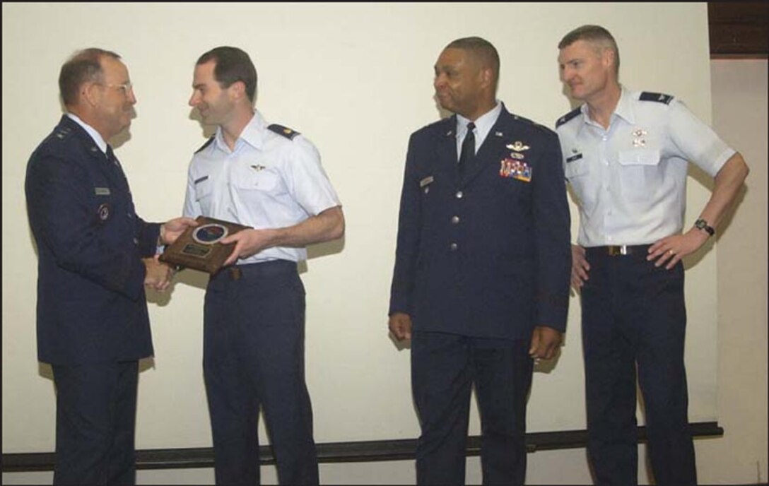 As Brig. Gen. Garry Dean, 1AF Vice Commander, and Col Steve Gregg, 142FW Commander look on, Major Rick Morris (second from left), 123d Fighter Squadron, receives the professional performer award for his role in the March Alert Force Evaluation from the 1st AF Commander, Maj. Gen. Hank Morrow.  The 142FW earned an "Outstanding" rating in the AFE - the best rating in wing history. 