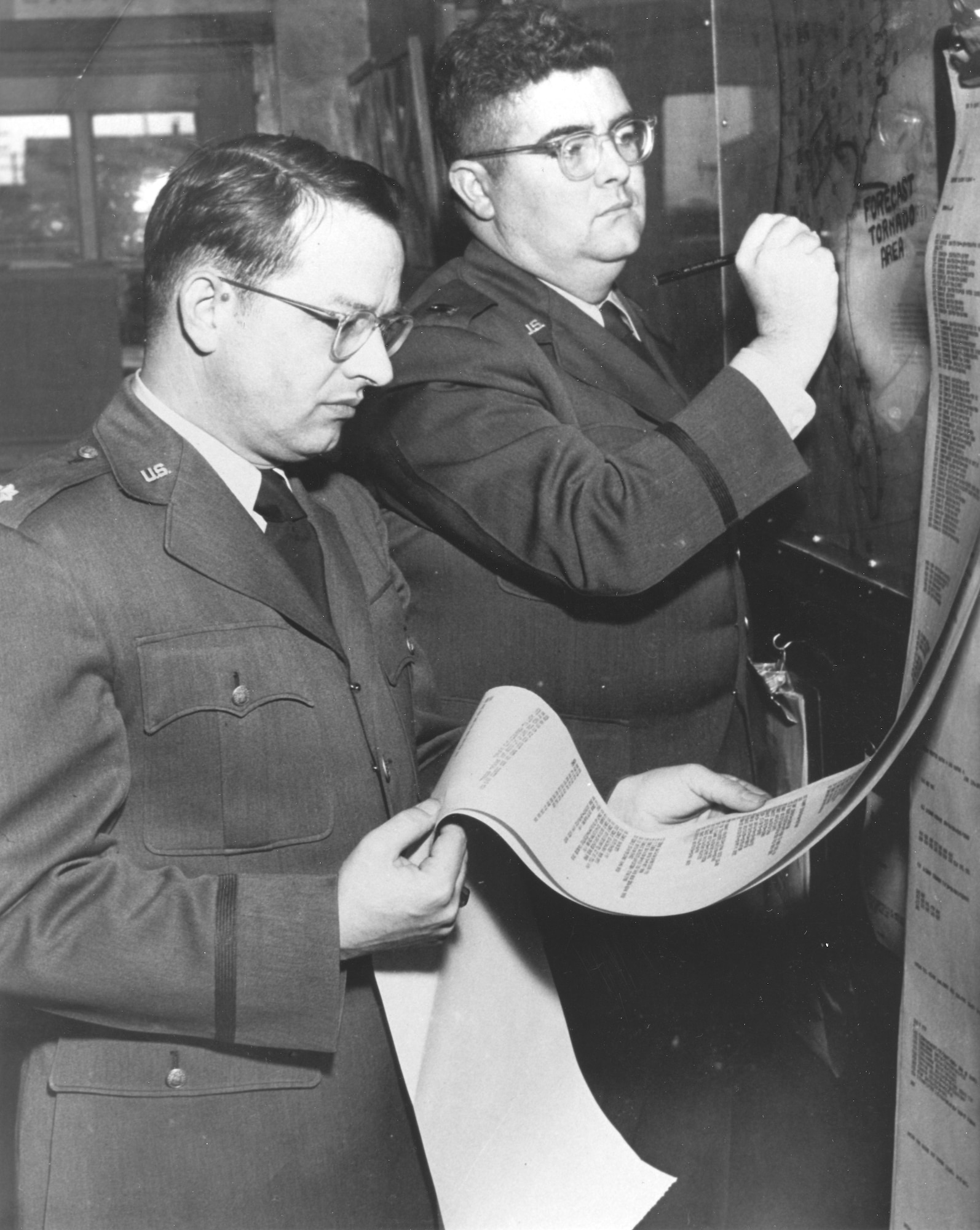 Tinker weathermen Maj. Ernest J. Fawbush, left, and Capt. Robert C. Miller forecasting tornado activity. (Air Force photo courtesy of Oklahoma City Air Logistics Center History Office)