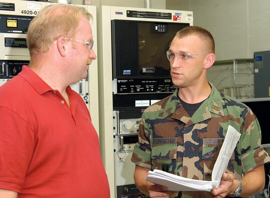 Electronics mechanic Jeff Hutchens discusses B-1 antennae work with 2nd Lt. Cory Steinbrecher recently.  As facility engineer for the B-1 Compact Range in Bldg. 3761, Lt. Steinbrecher ensures every piece of test equipment in the sole source facility is kept upgraded and in top shape. (Air Force photo Margo Wright)
