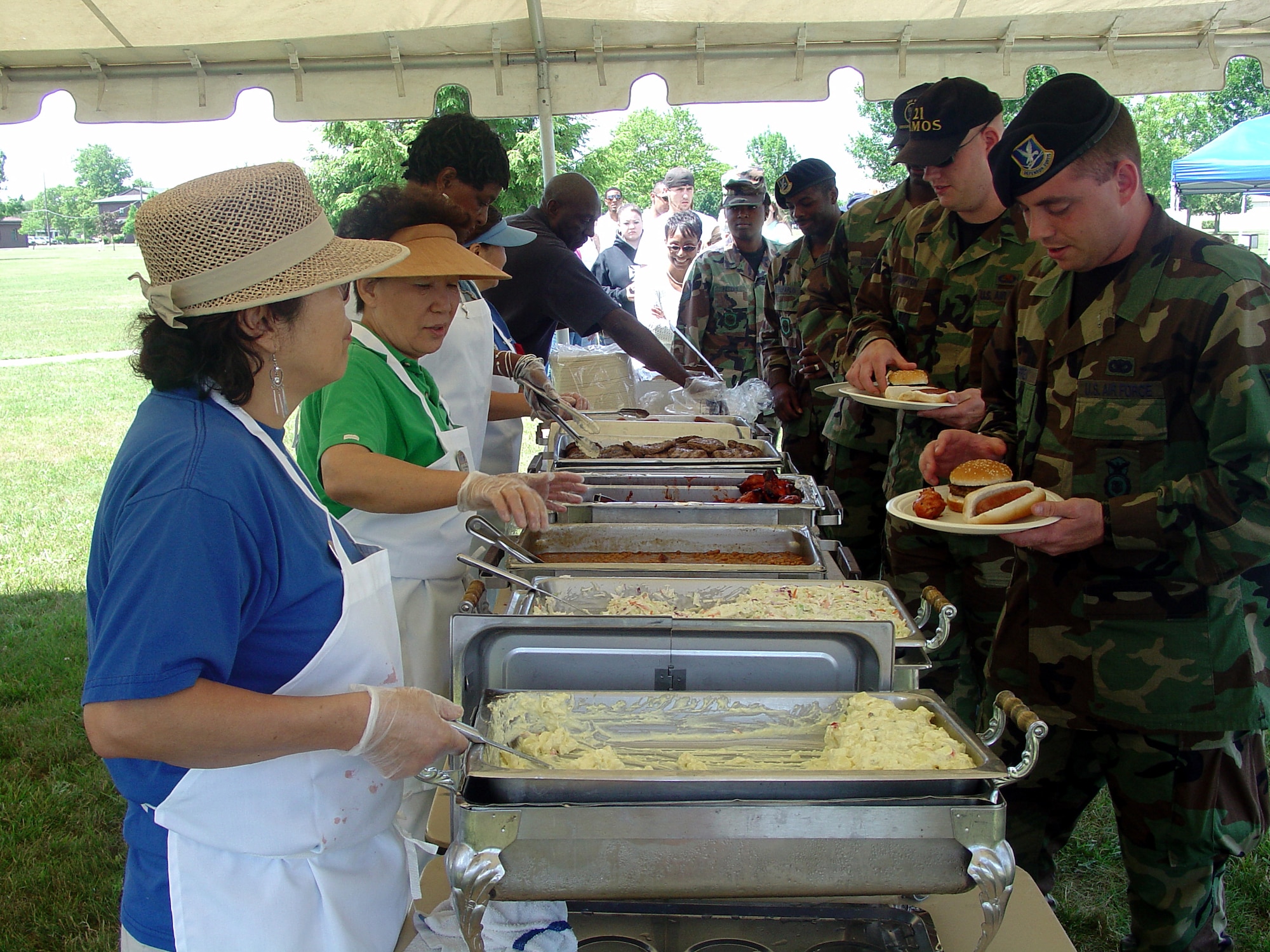 Team McGuire members enjoy hamburgers, hot dogs, potato salad and more at the annual Match Up picnic, hosted by the 305th Services Squadron, here June 22. Personnel and their families attended the event featuring a dunk tank, hula hoop contest, free give-aways, a moon bounce and more. Match Up game pieces were also given out. (U.S. Air Force photo by Airman 1st Class Rebekah Phy)